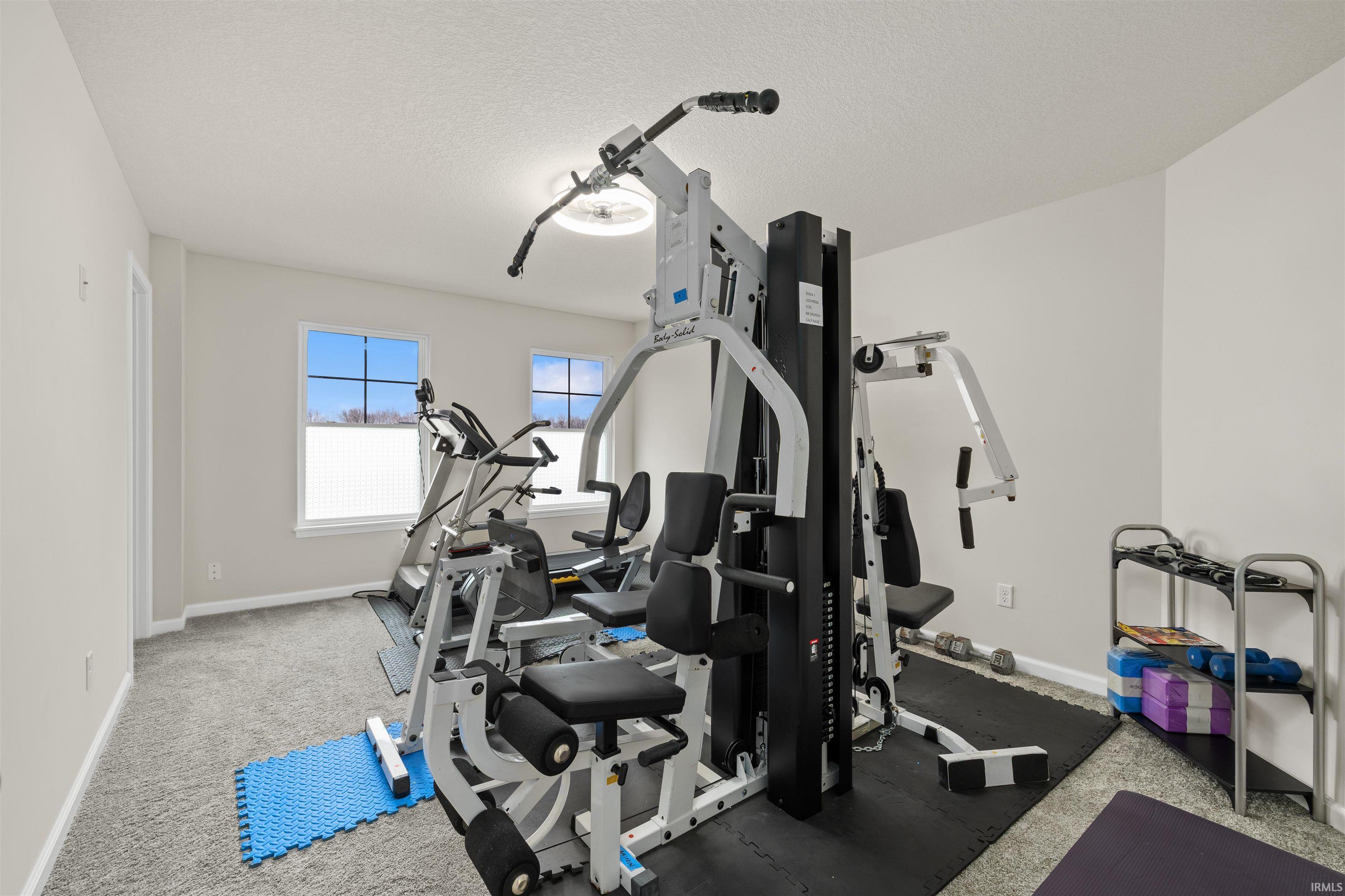 Exercise room with a textured ceiling