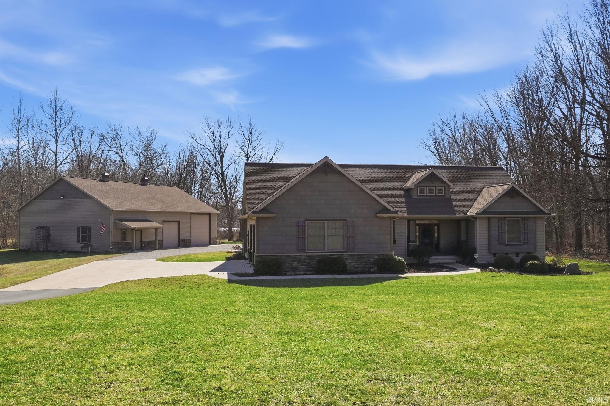 Craftsman inspired home with a front lawn, concrete driveway, and covered porch