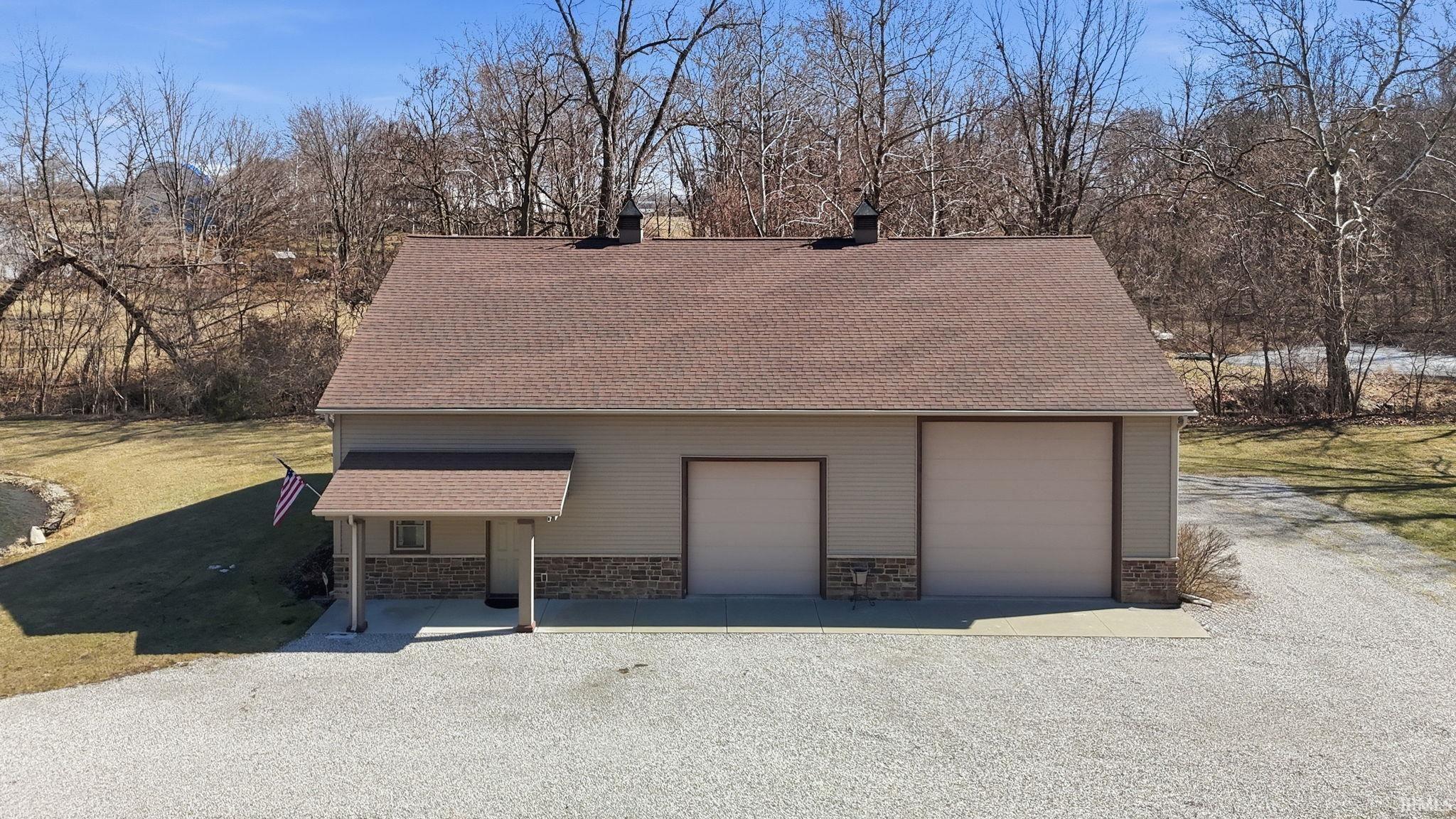 Detached garage with view of wooded area