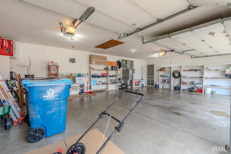 Garage featuring heating unit and a garage door opener