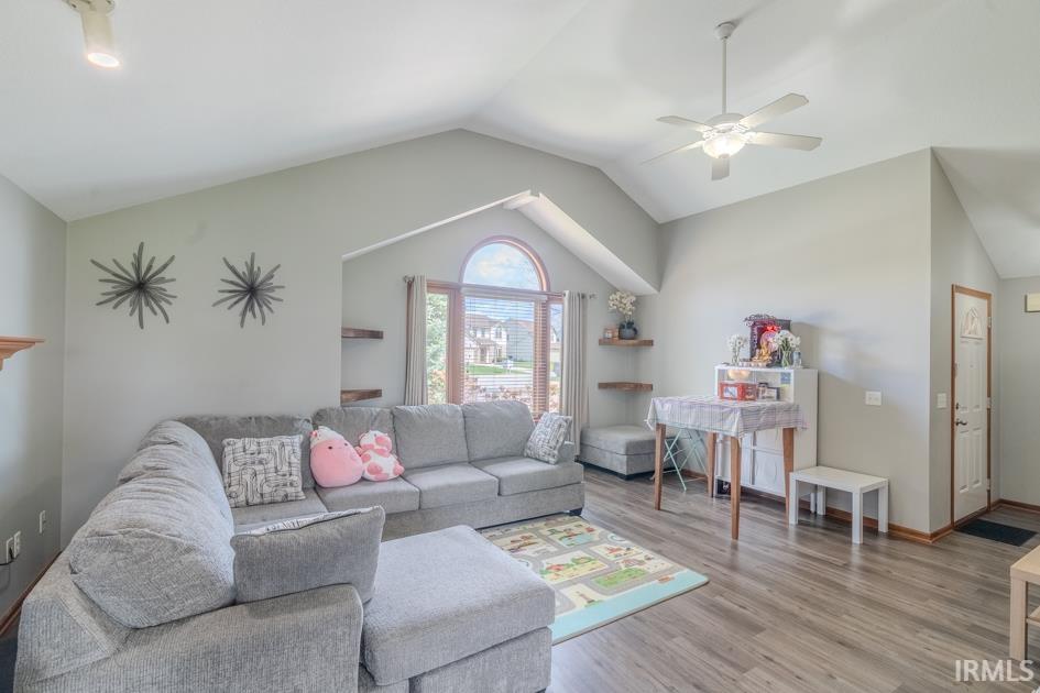 Living room featuring a ceiling fan and wood finished floors