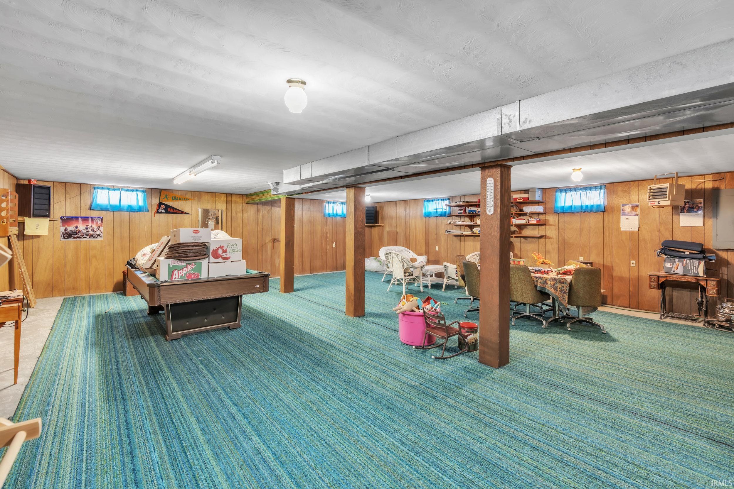 Rec room  with wood walls and a heating unit