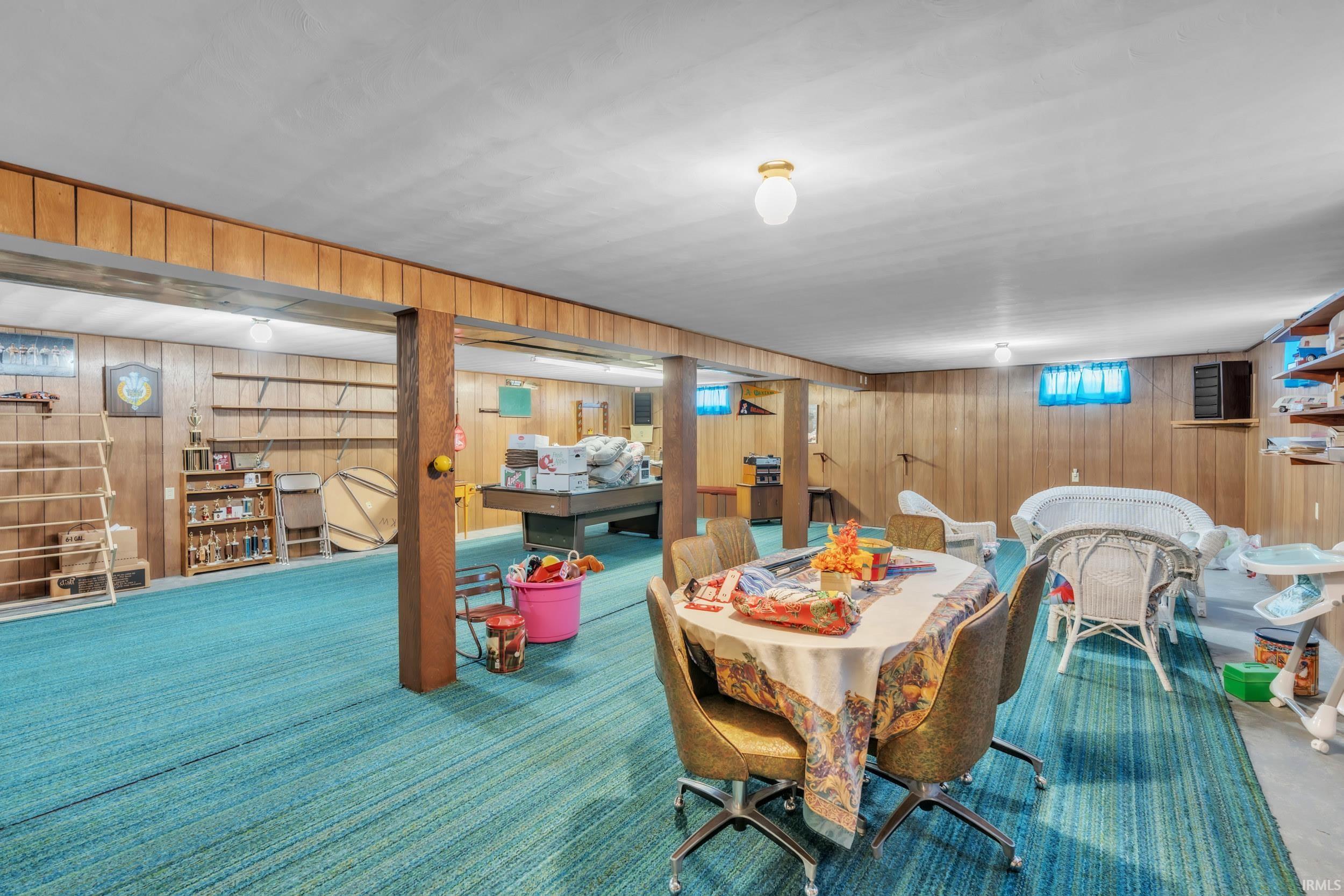 Family room featuring wooden walls and carpet floors