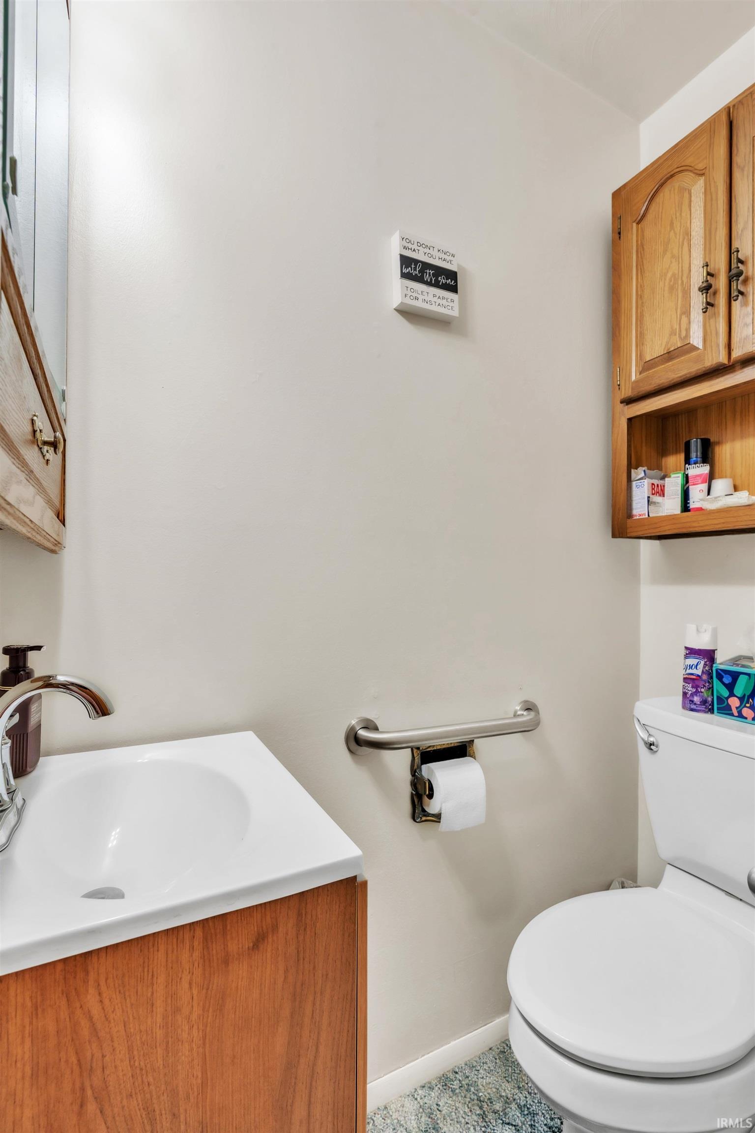 Half bath featuring vanity and toilet