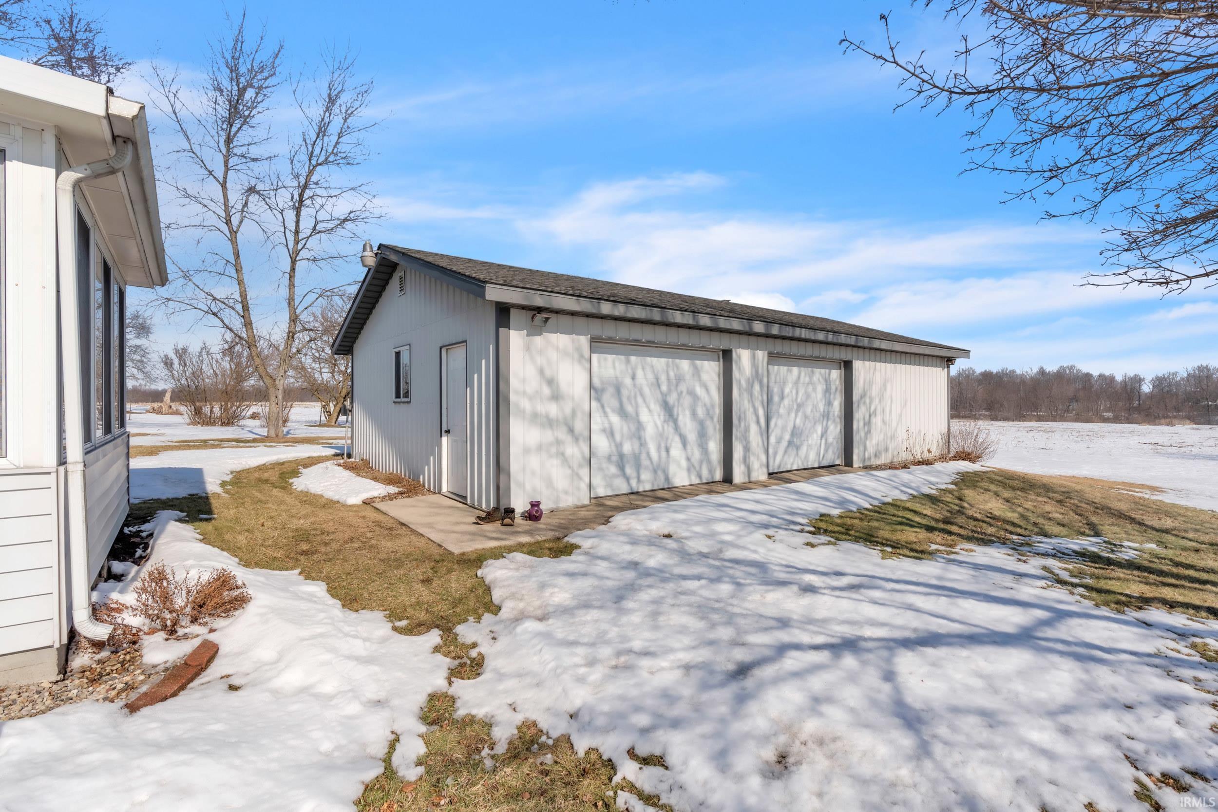 Snow covered garage with a garage