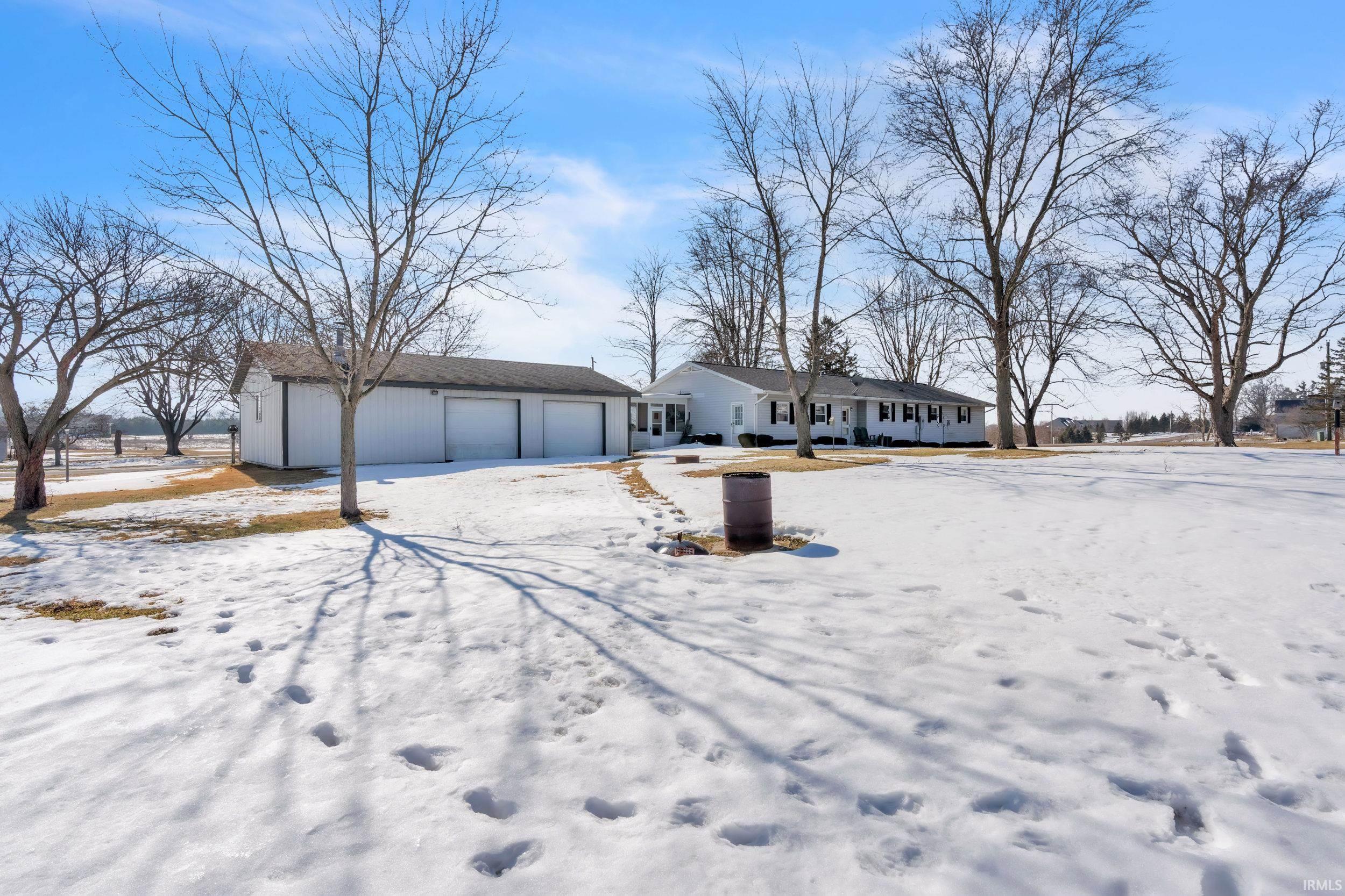 View of front of house with a detached garage