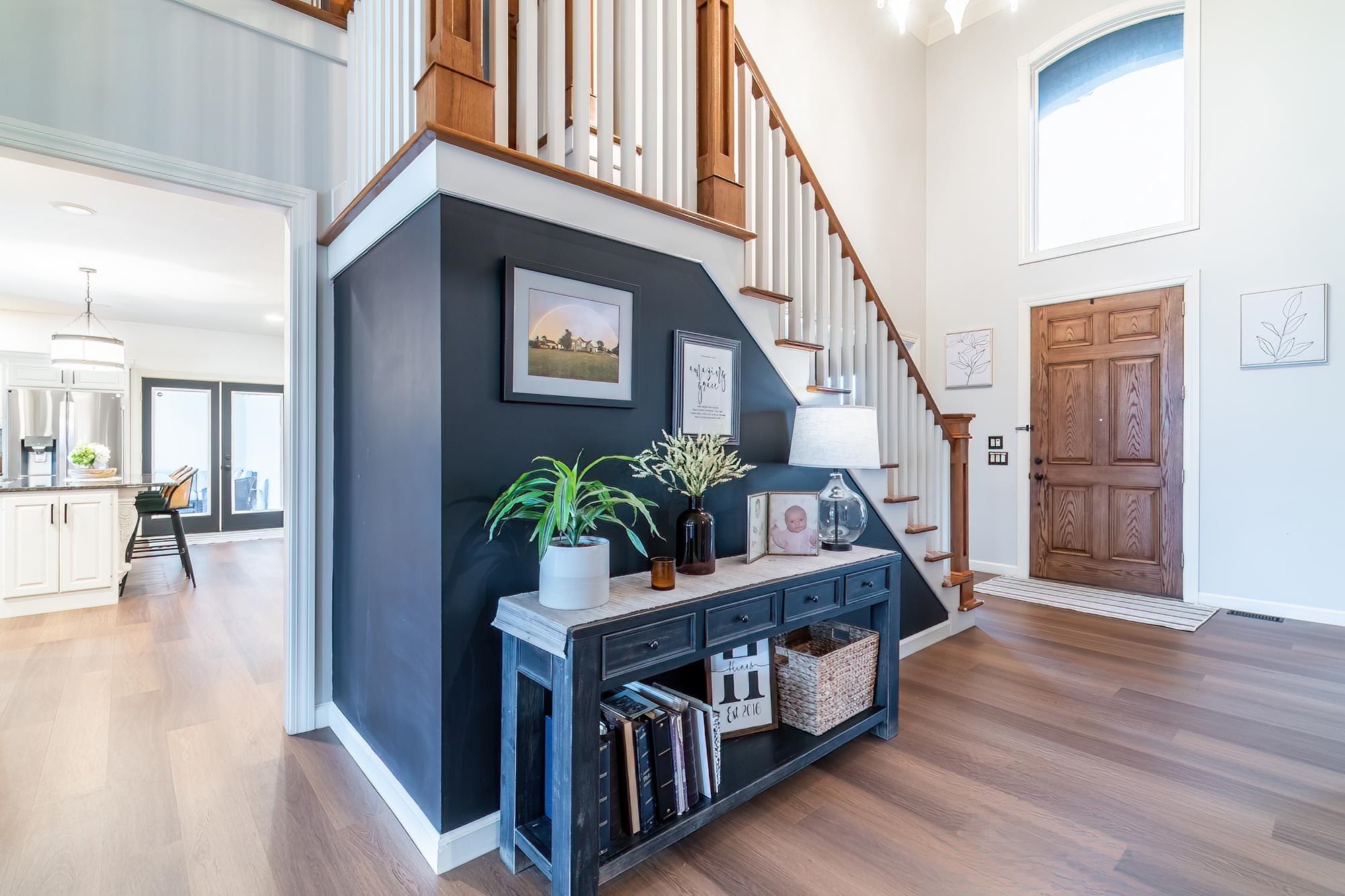 Entryway with dark wood-style floors and a high ceiling