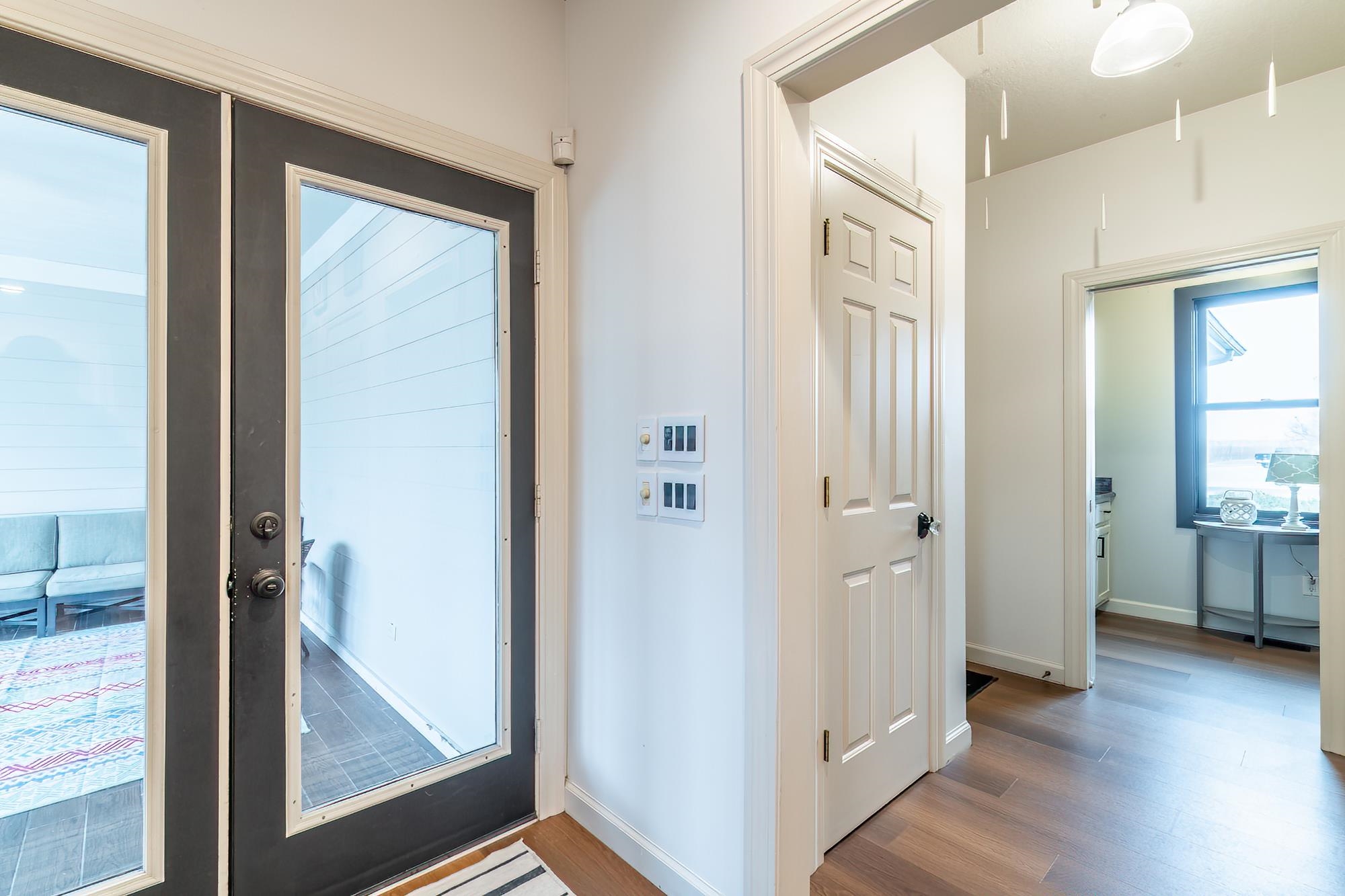 Entrance foyer with french doors and light wood-style floors
