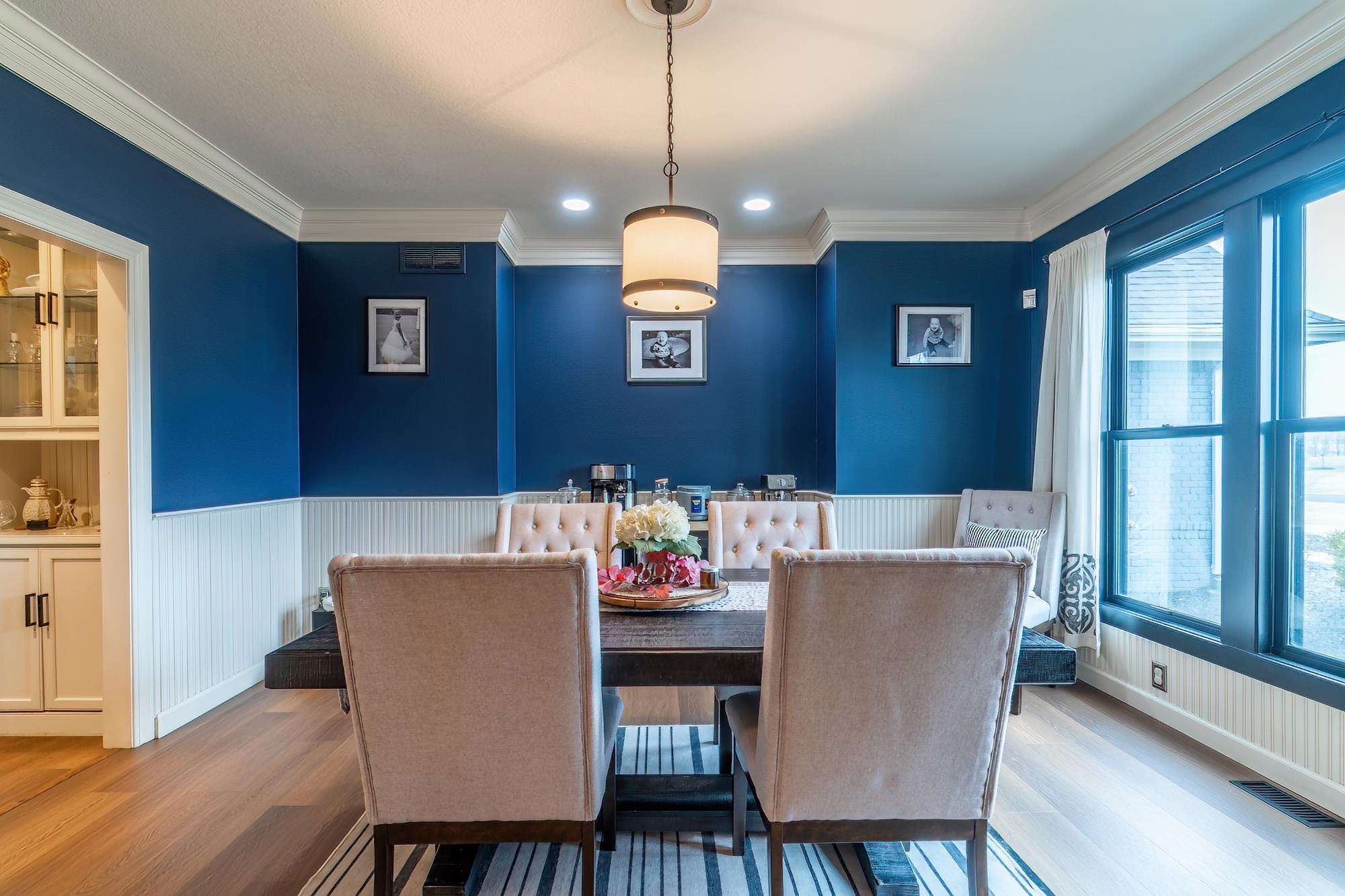 Dining area featuring ornamental molding, wood finished floors, wainscoting, and recessed lighting