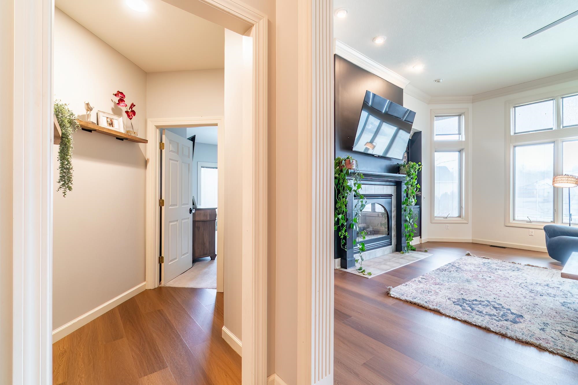 Hall with dark wood-style floors, recessed lighting, and crown molding
