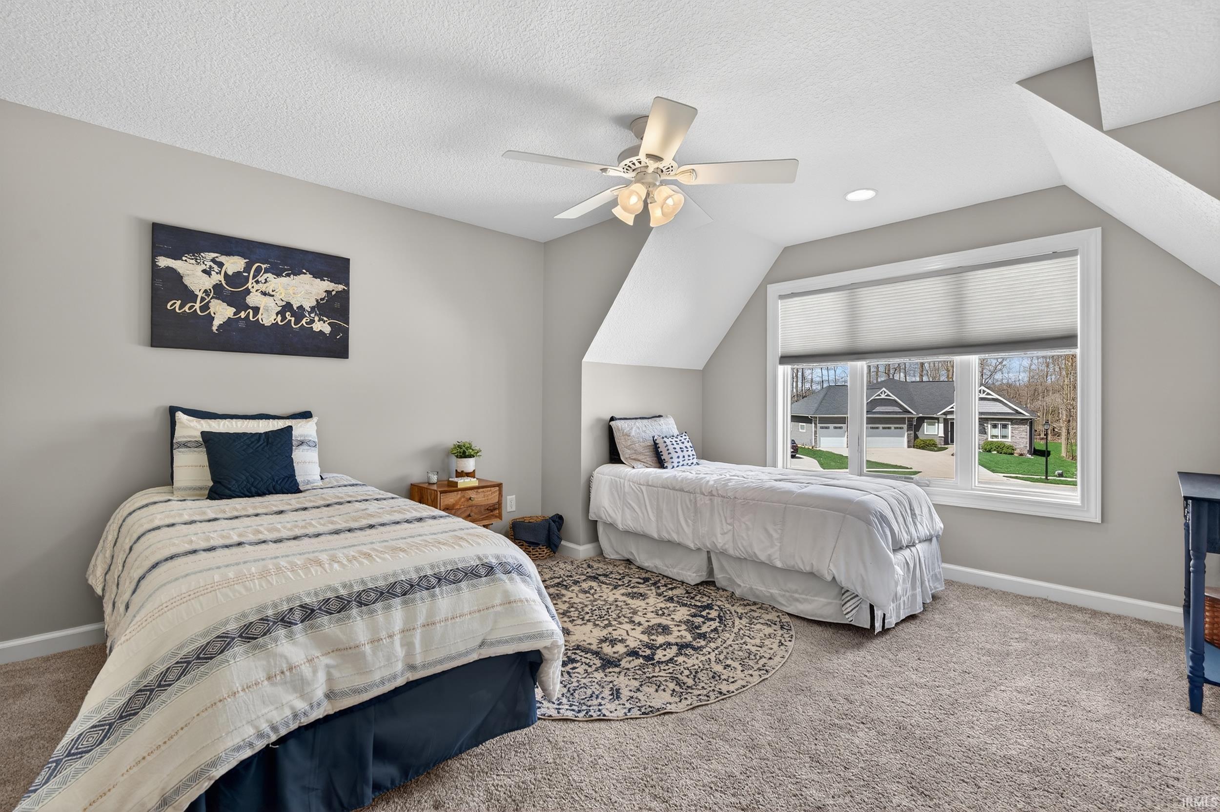 Carpeted bedroom featuring baseboards and ceiling fan