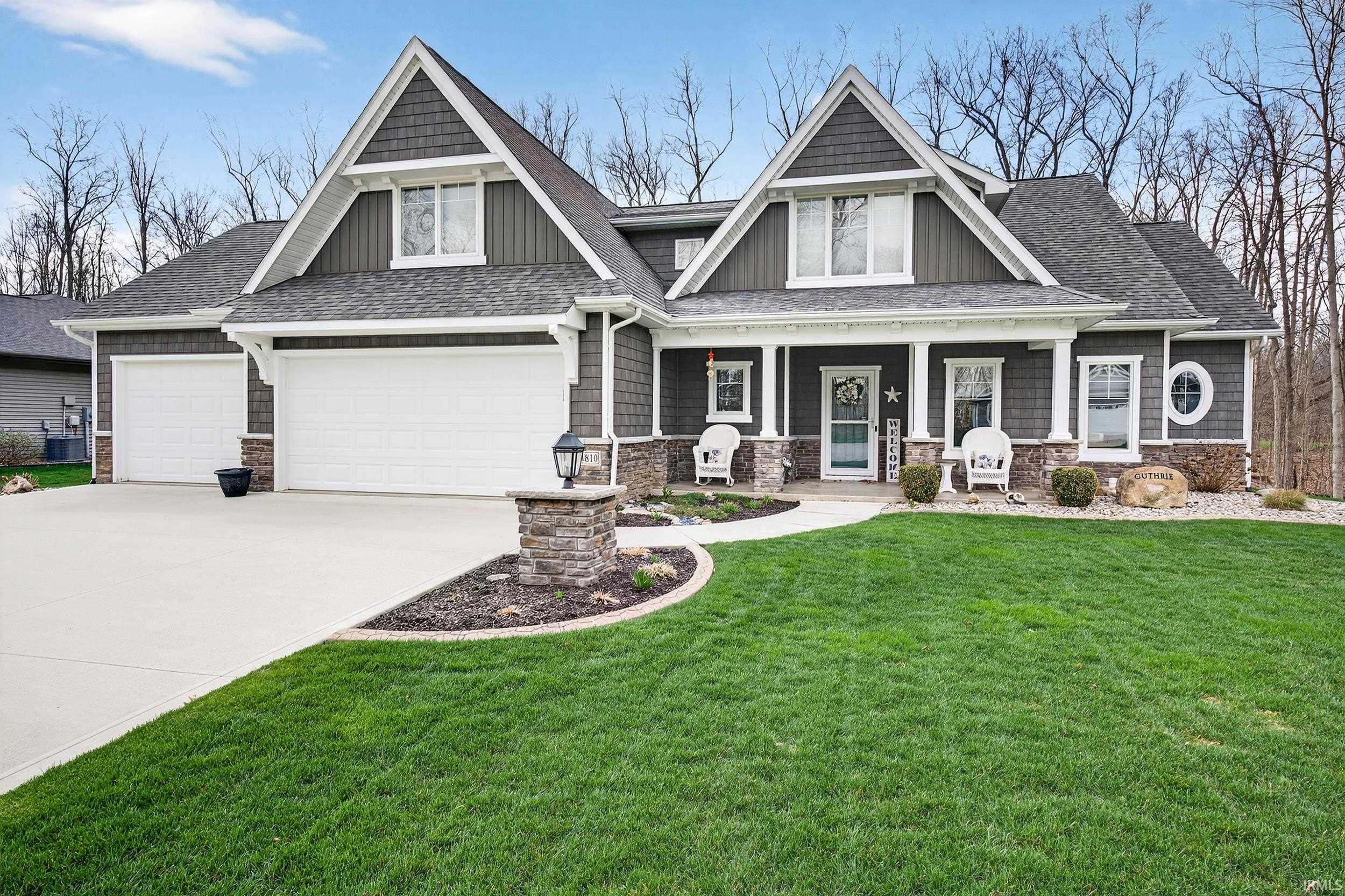 Craftsman inspired home with a porch, a front yard, roof with shingles, and concrete driveway