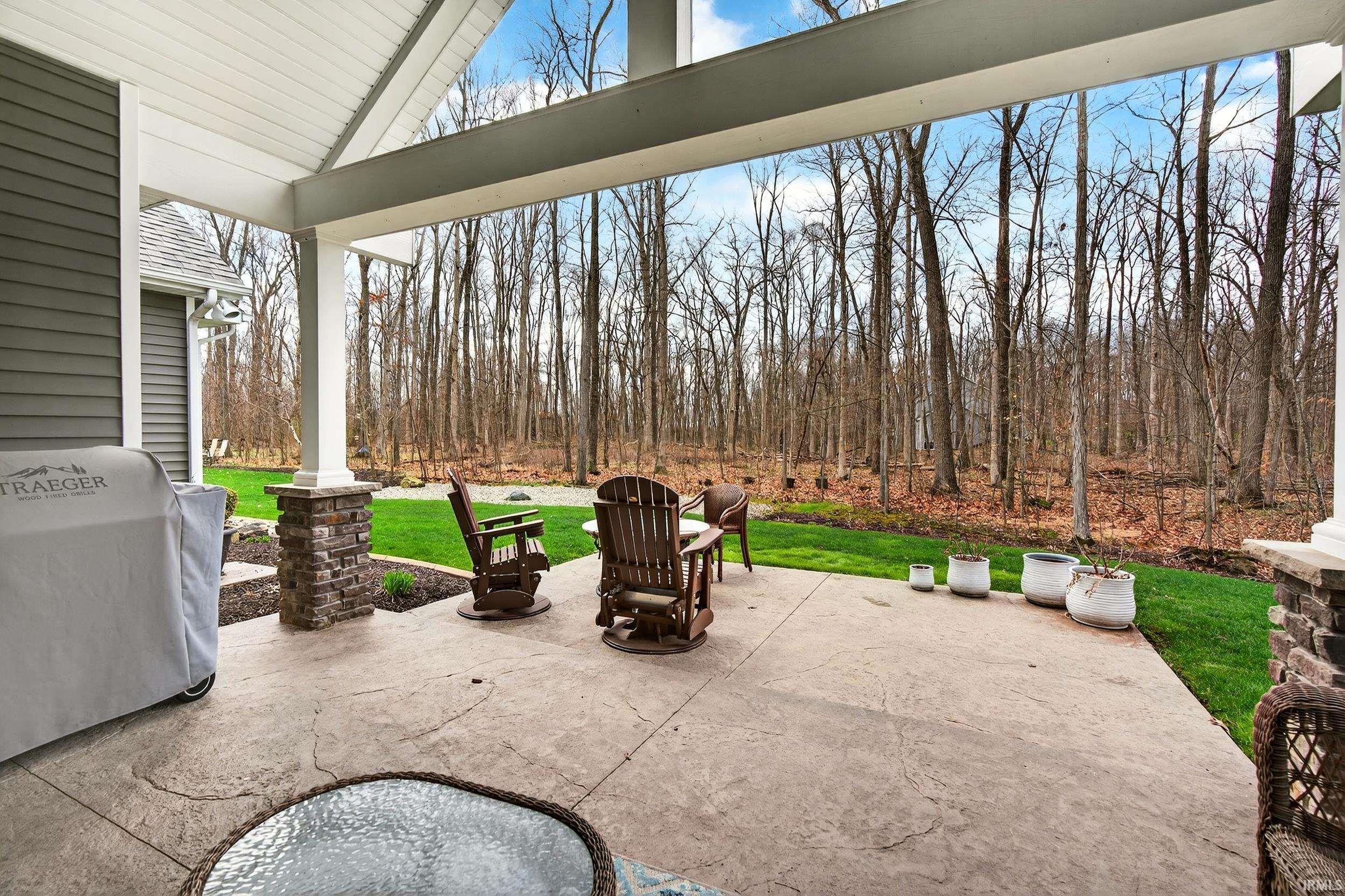 View of patio with a grill