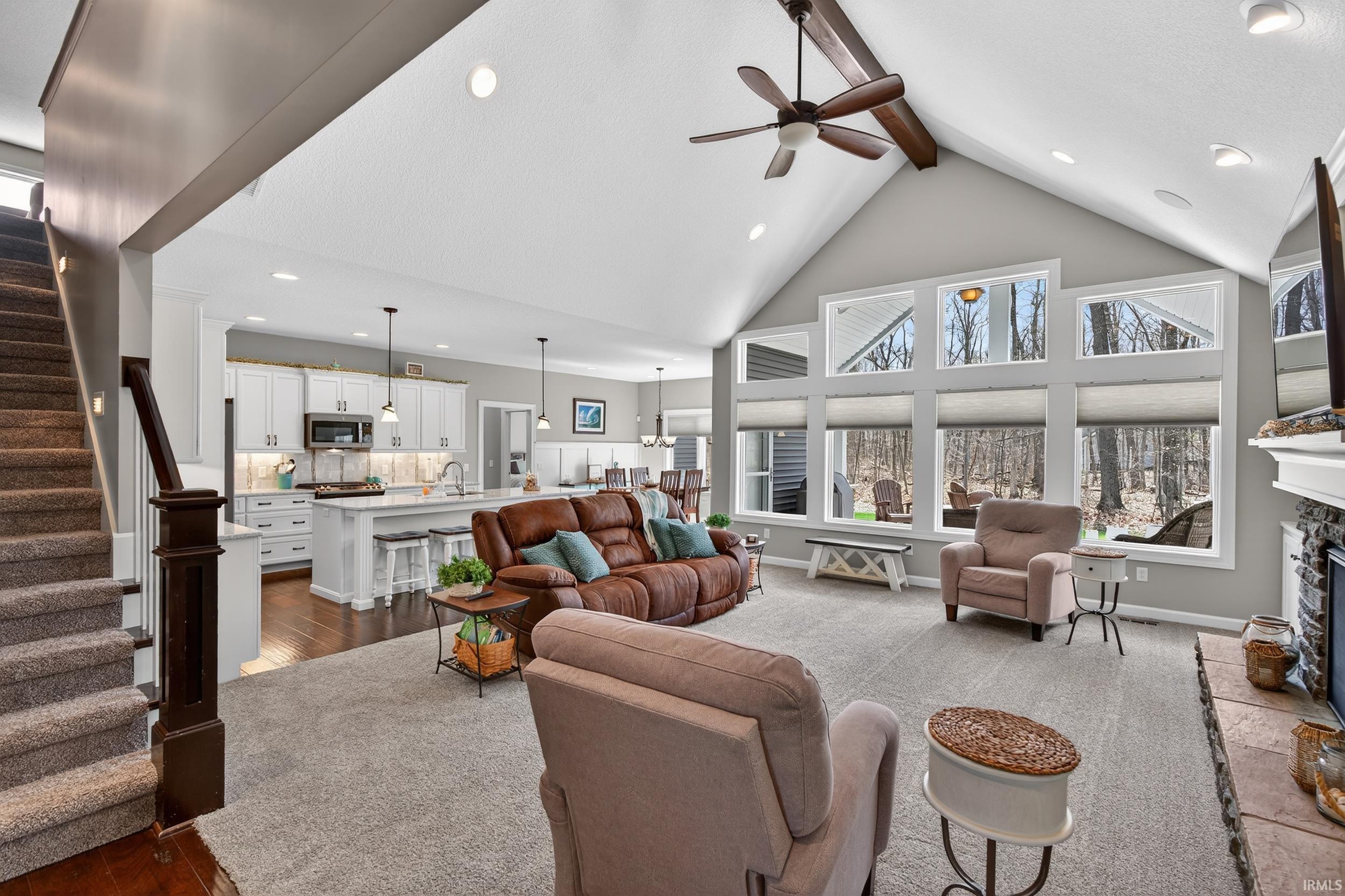Living room featuring recessed lighting, a fireplace, a ceiling fan, plenty of natural light, and dark wood finished floors