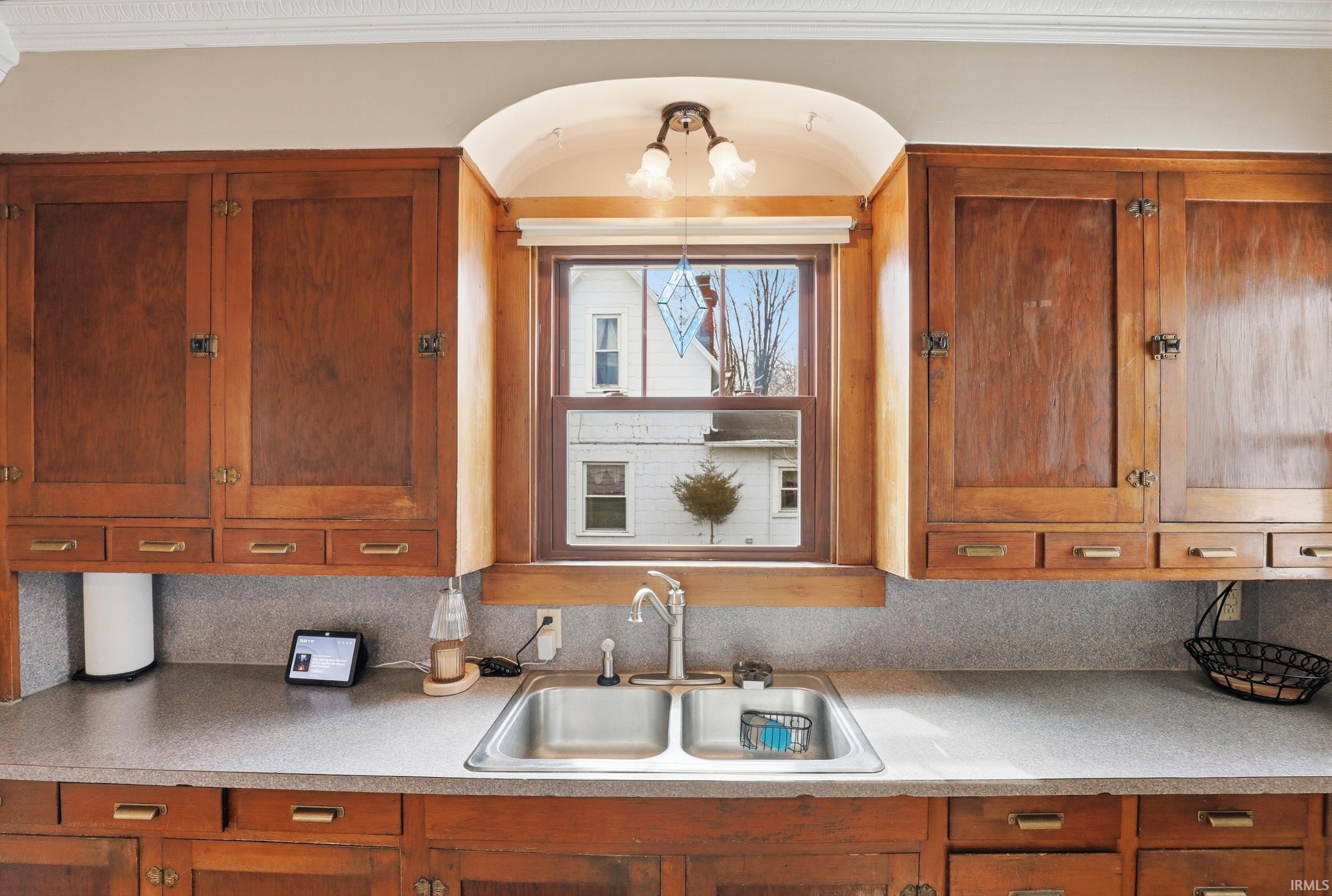Kitchen featuring wood finish cabinetry and light countertops