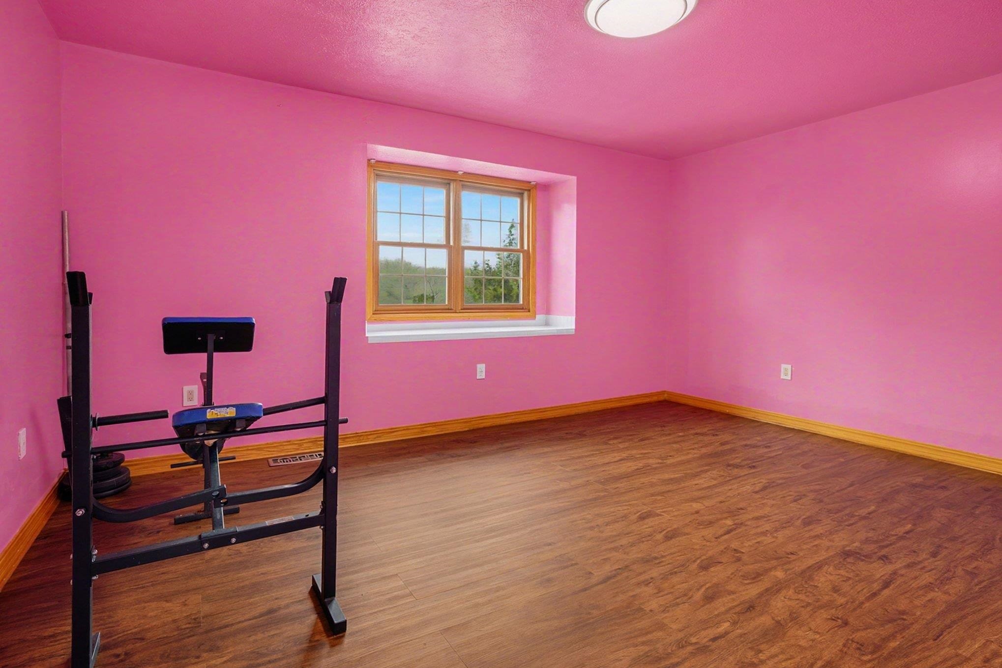 Spare room featuring dark wood finished floors and a textured ceiling