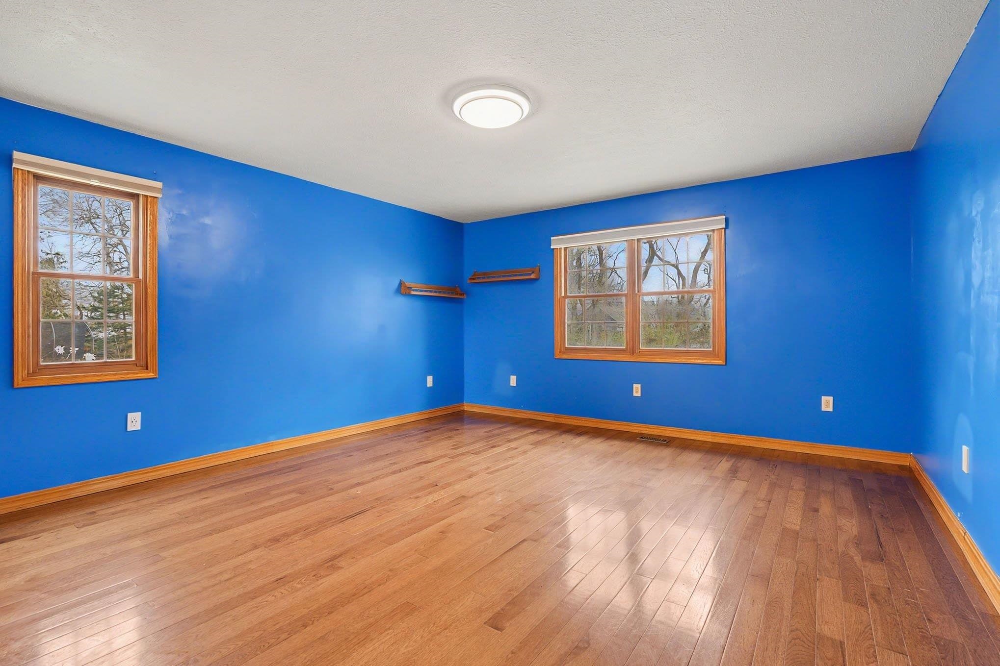Unfurnished room featuring light wood finished floors and baseboards