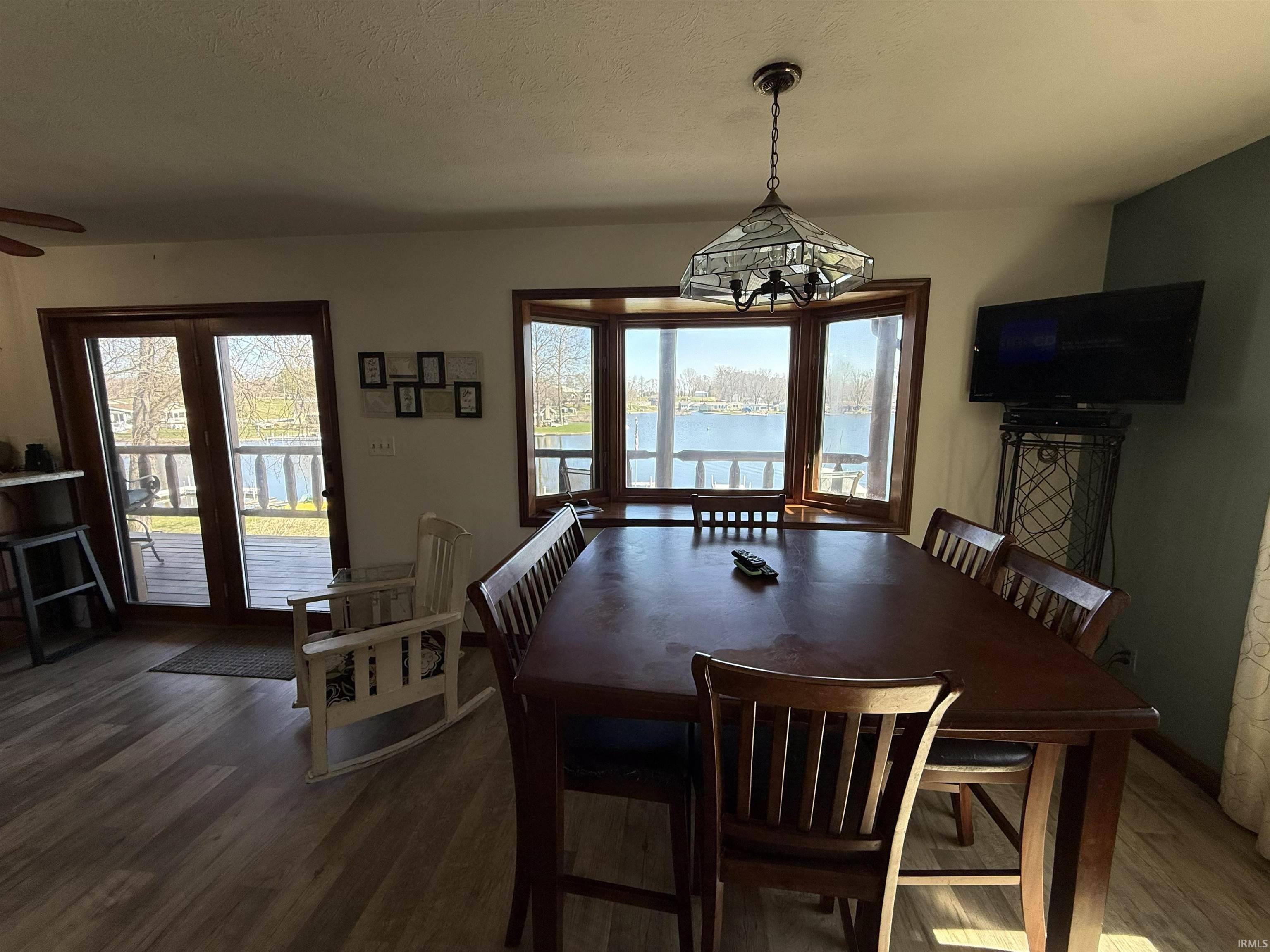 Dining room with wood finished floors and plenty of natural light