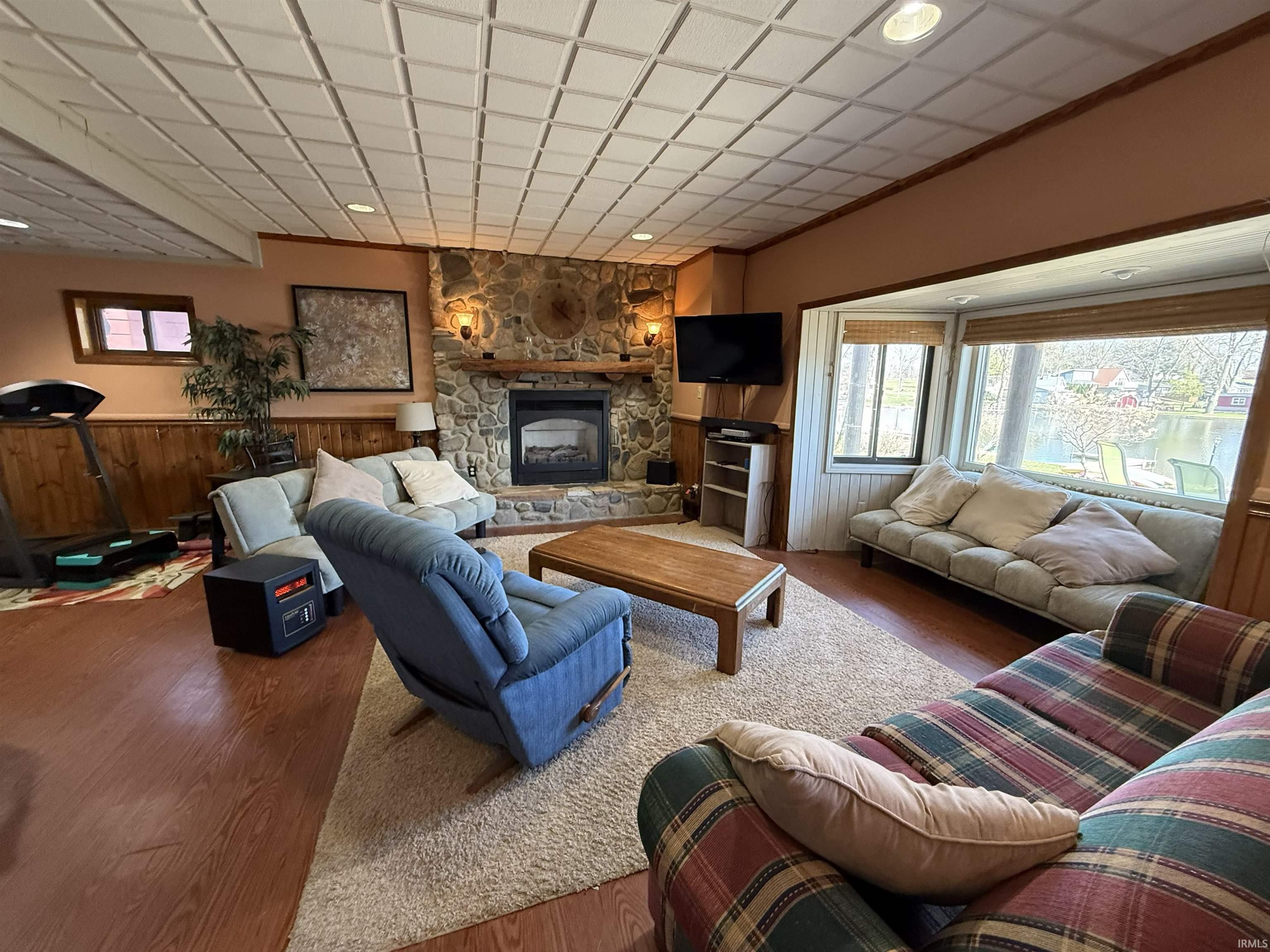 Living area featuring a fireplace, wood finished floors, healthy amount of natural light, and recessed lighting