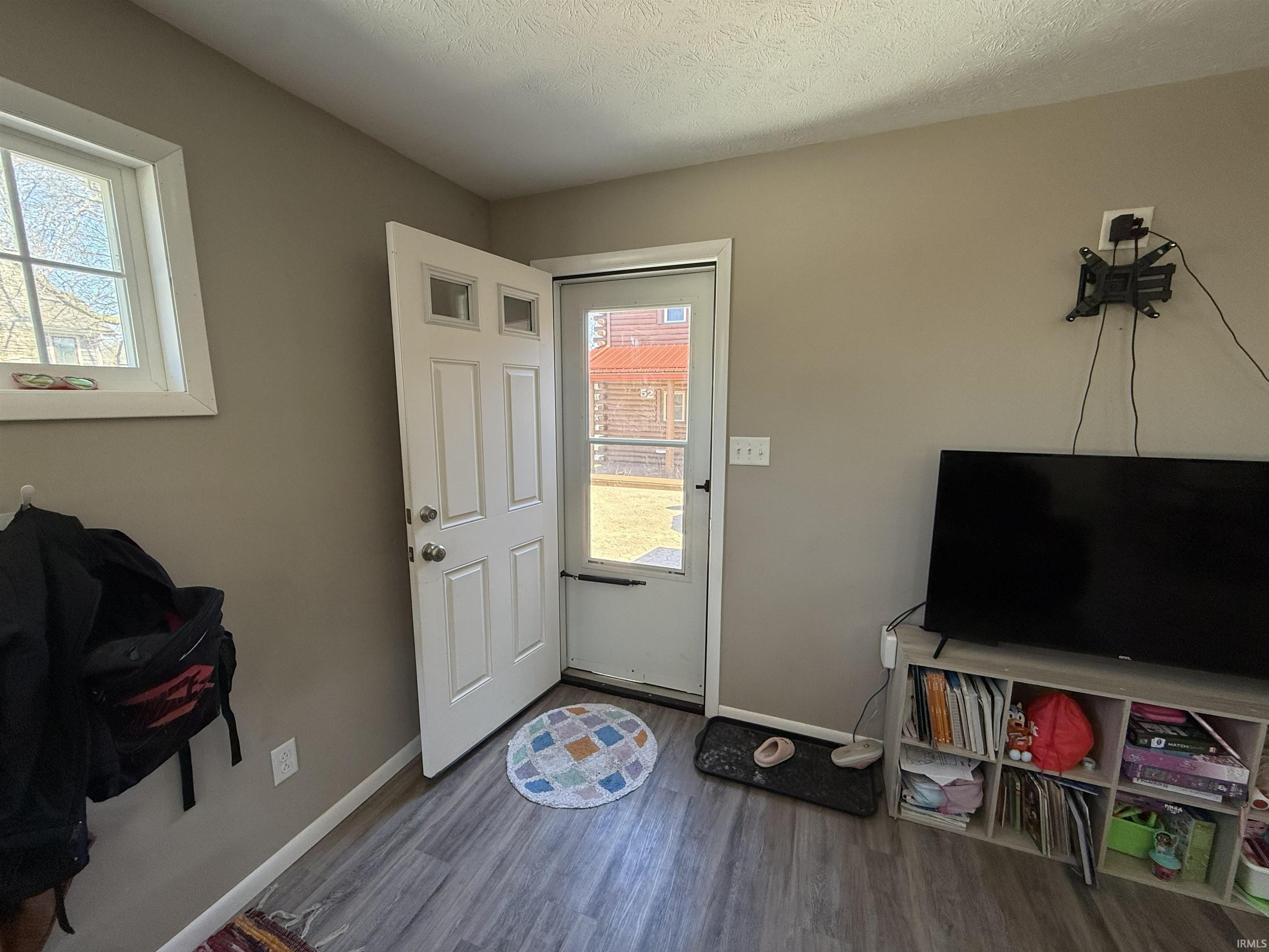 Entrance foyer featuring wood finished floors and a textured ceiling