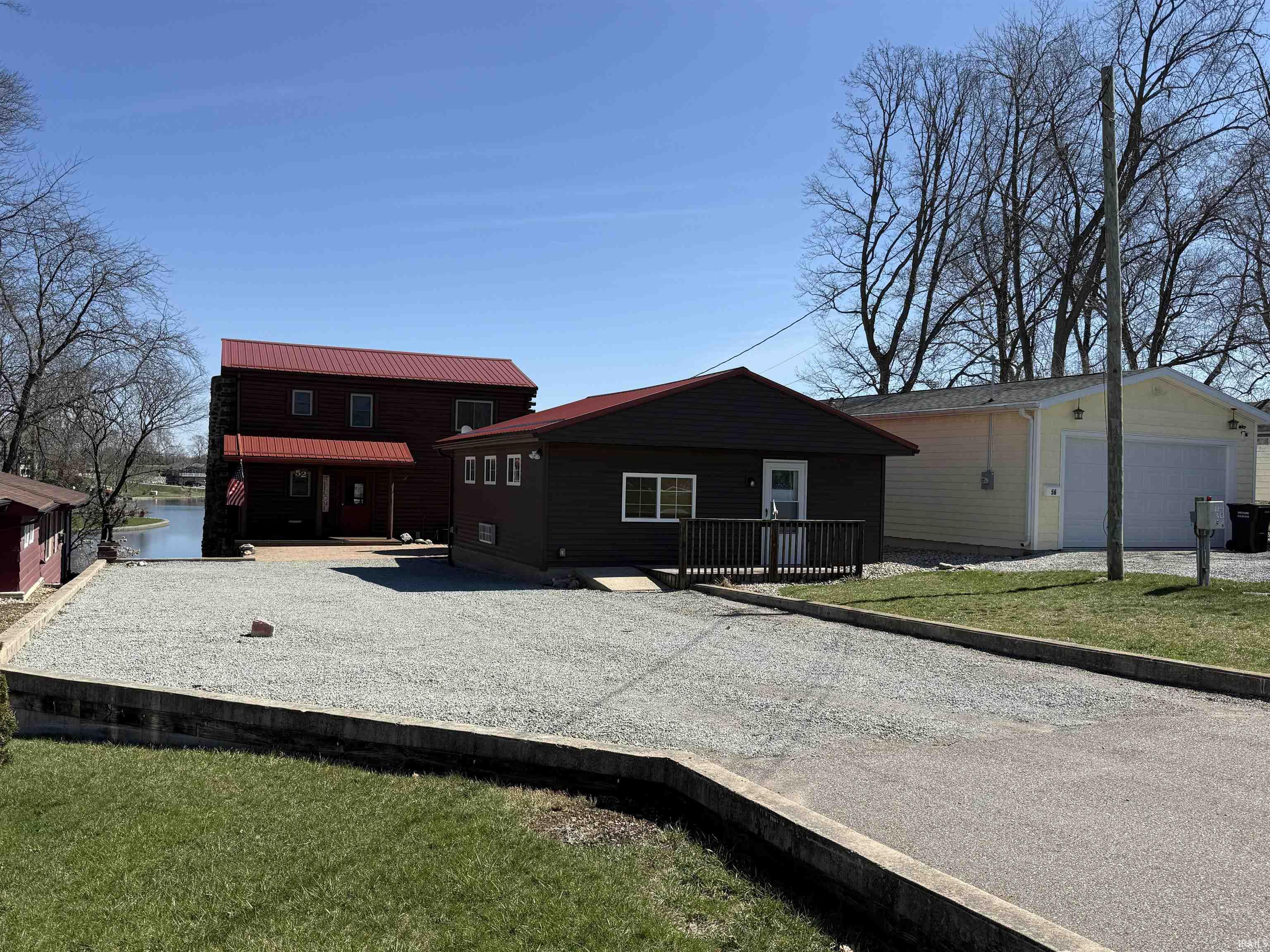 View of front facade featuring a metal roof and a front yard