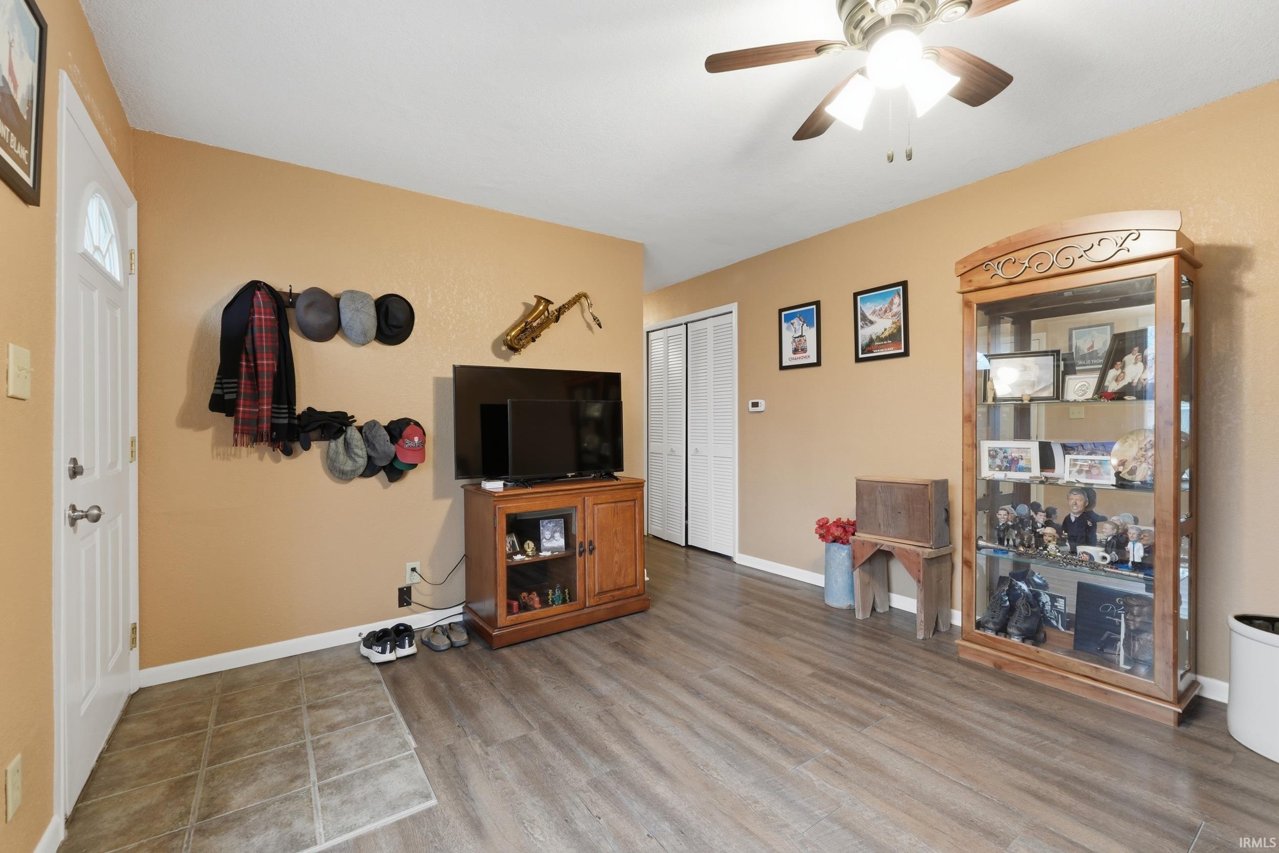 Living room featuring ceiling fan and light wood-style floors