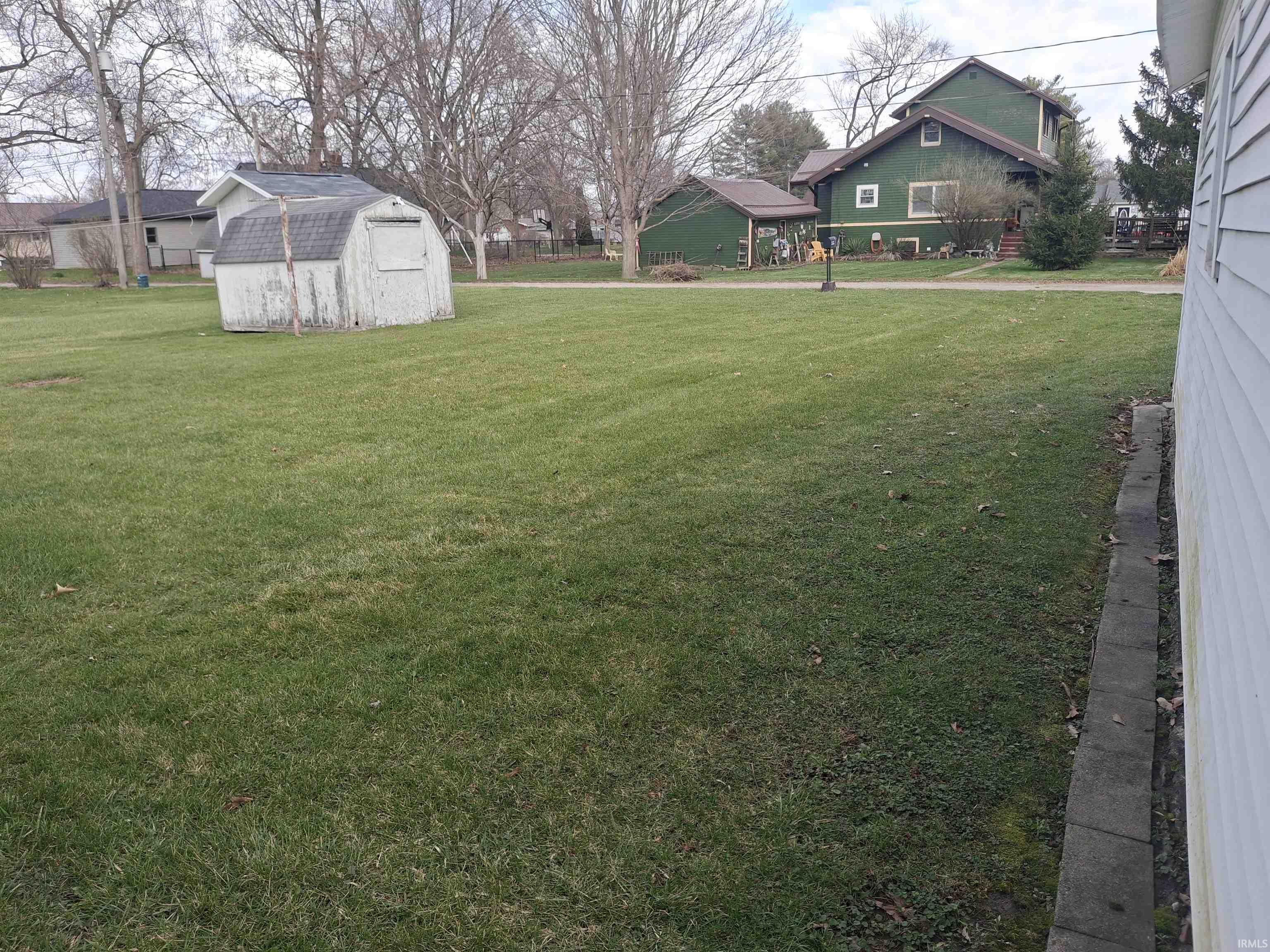 View of grassy yard with a shed