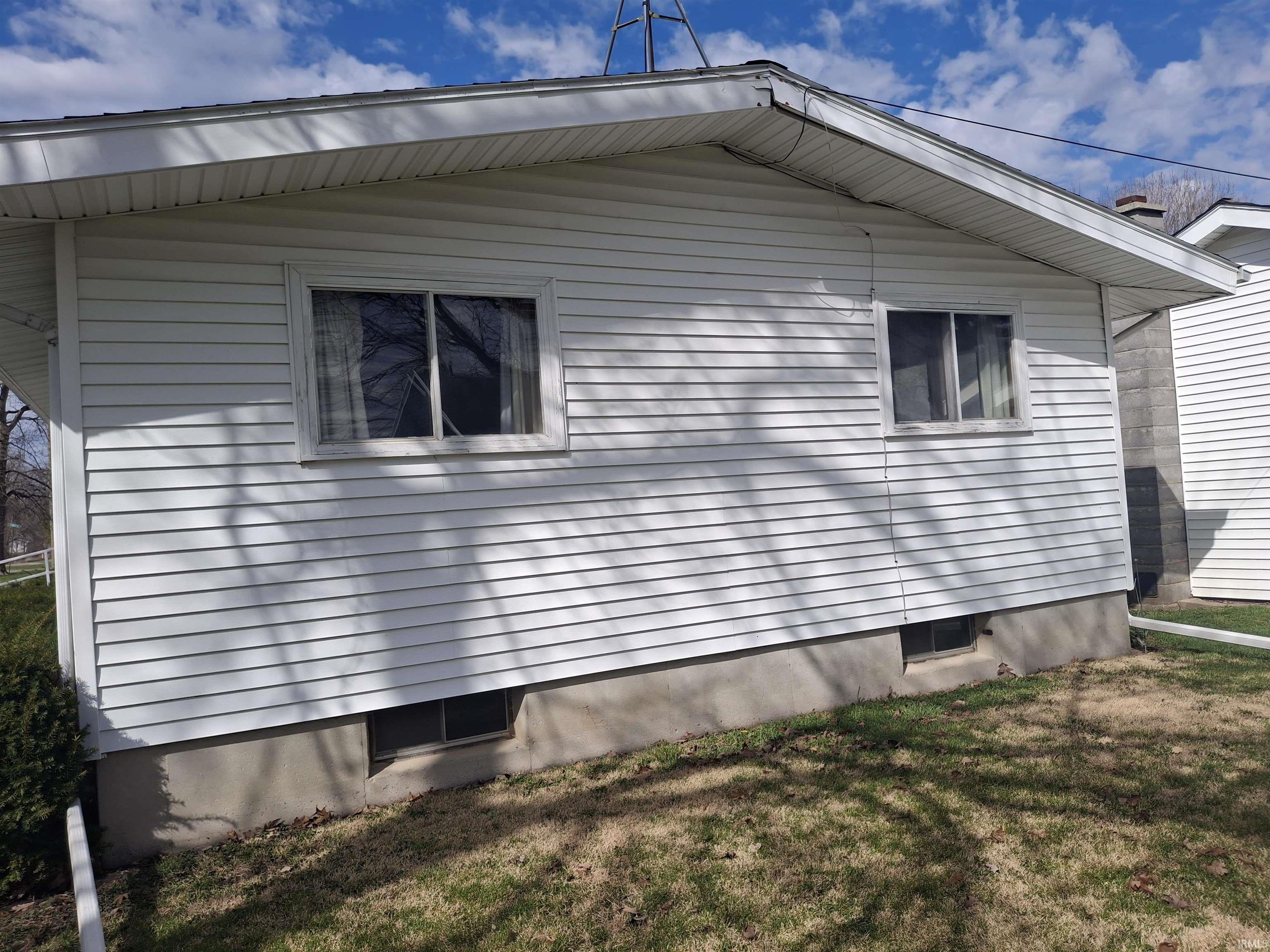 View of home's exterior with a yard
