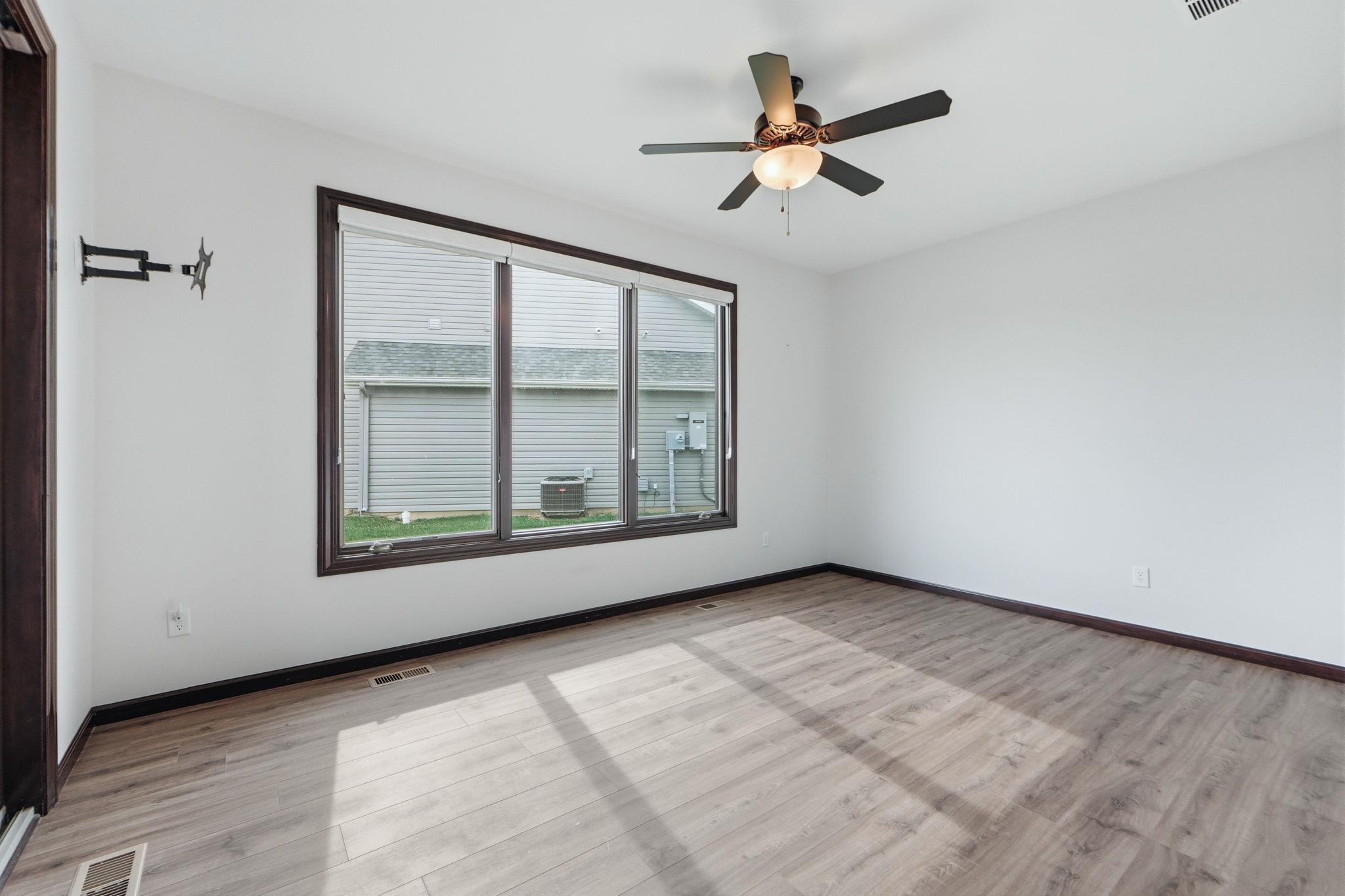 Spare room featuring ceiling fan and light wood-style flooring