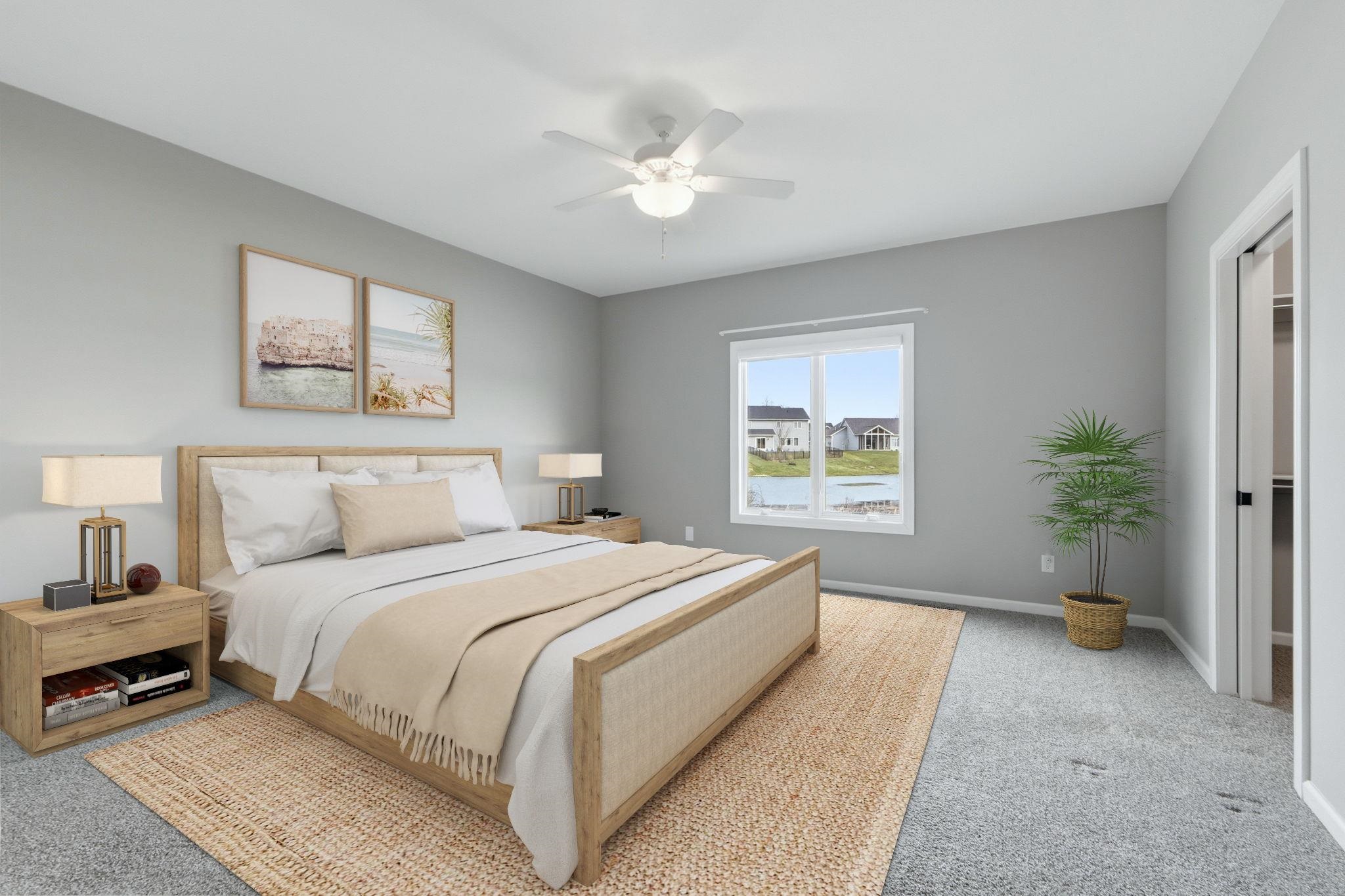 Bedroom featuring carpet, a ceiling fan, and a spacious closet