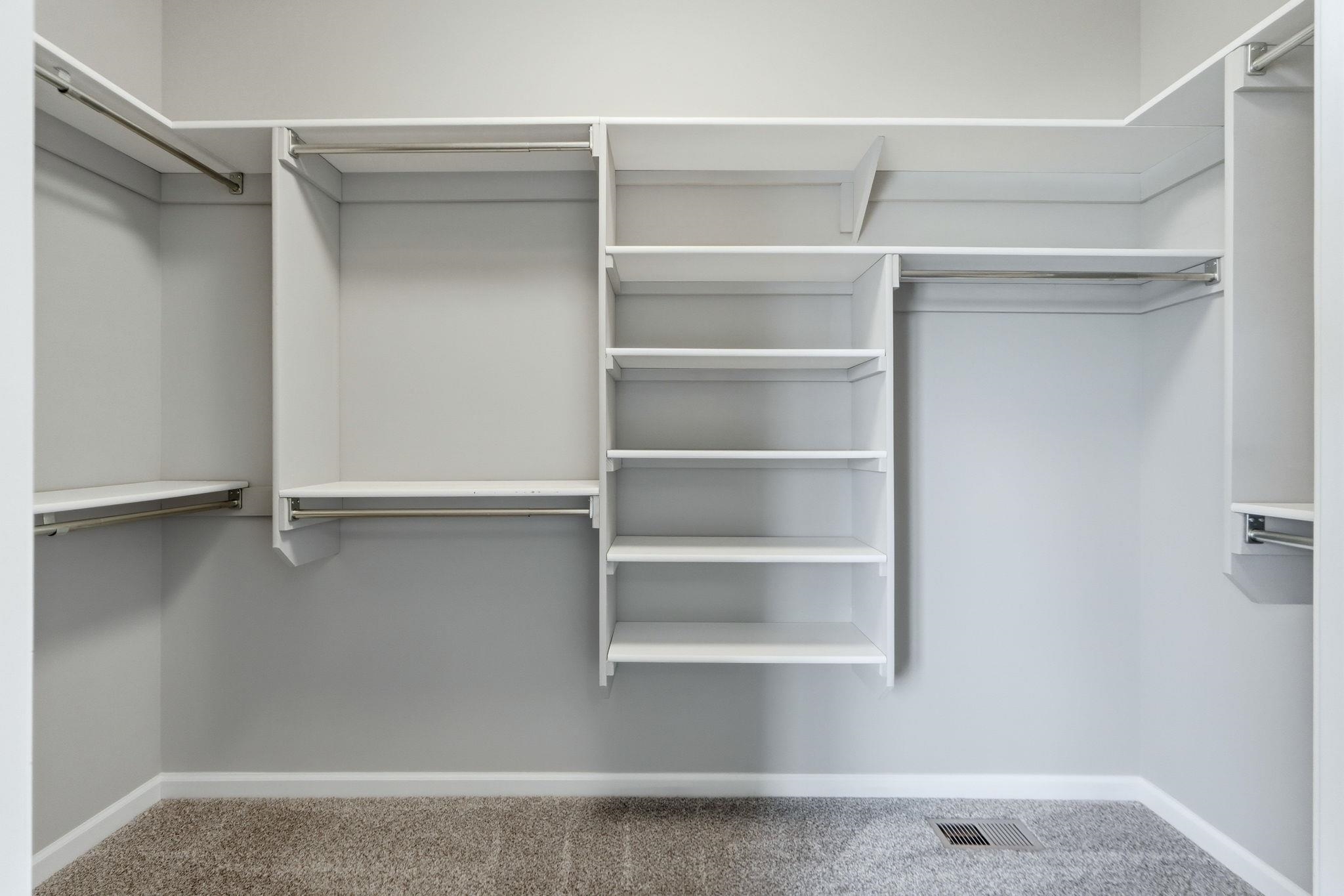 Walk in closet featuring light carpet