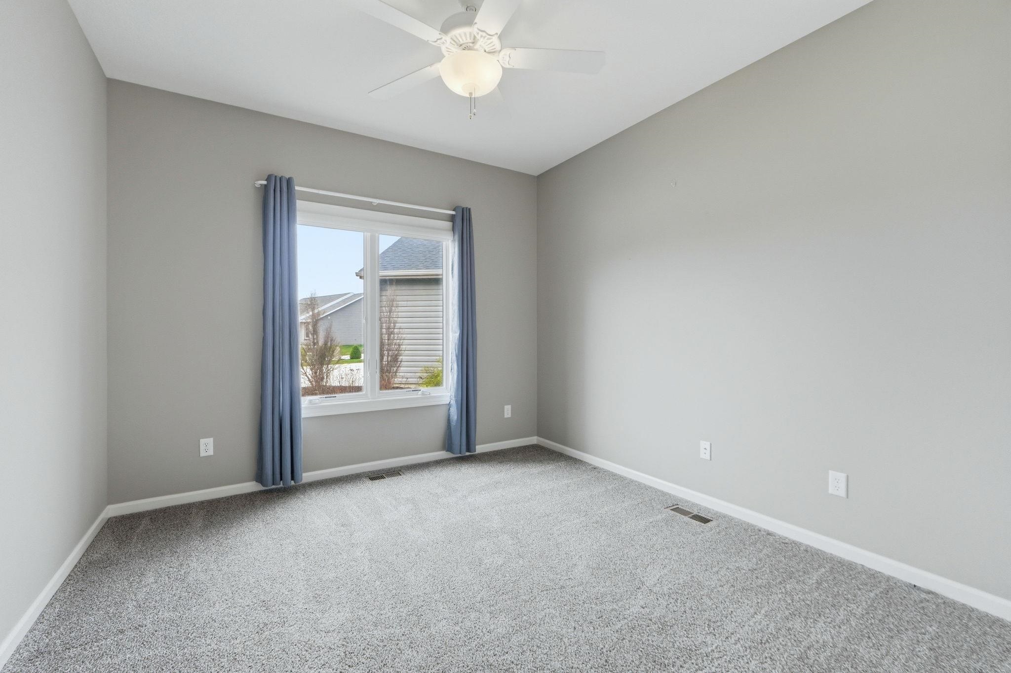 Spare room with light colored carpet and a ceiling fan