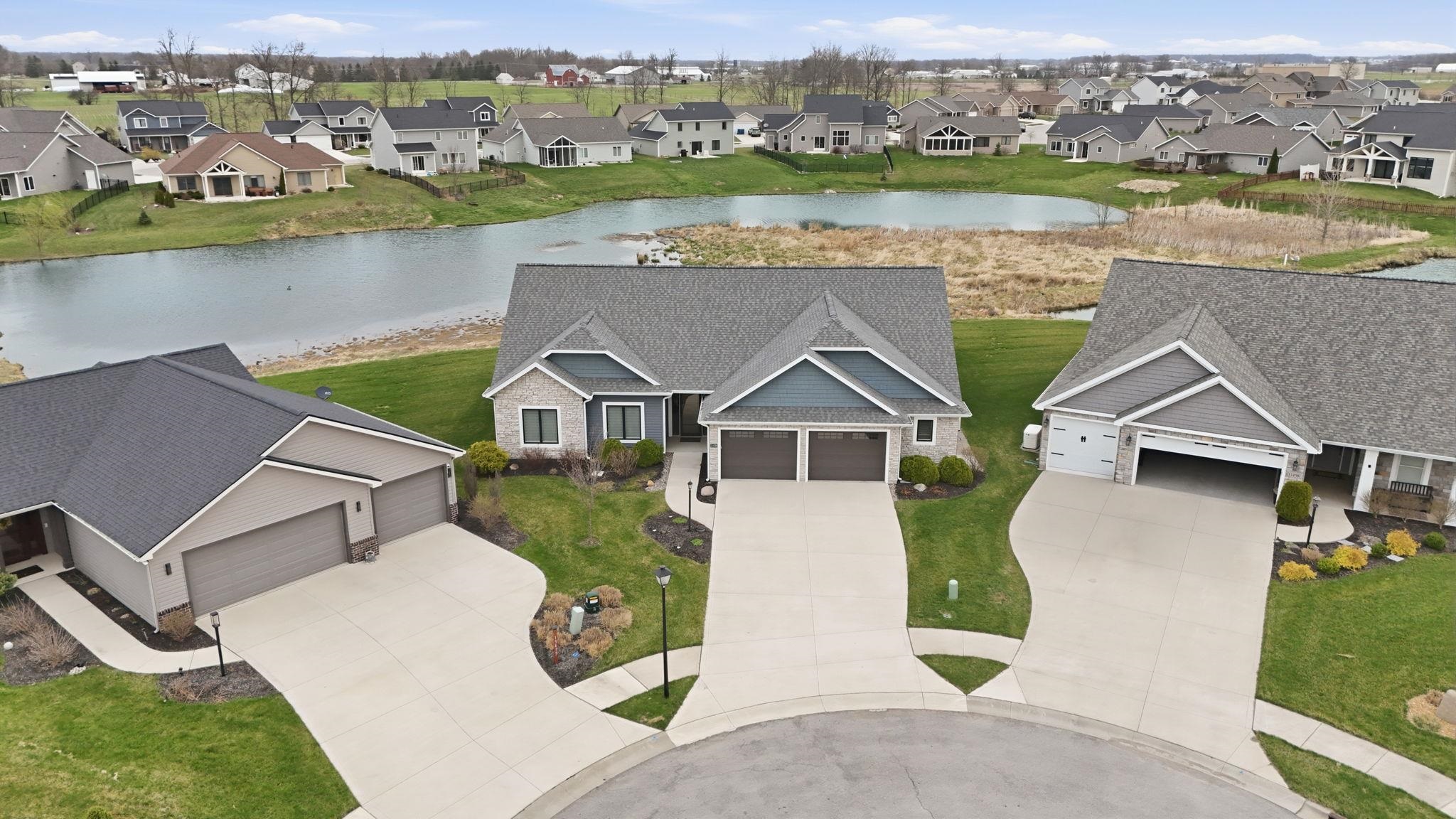 Aerial perspective of suburban area featuring a large body of water