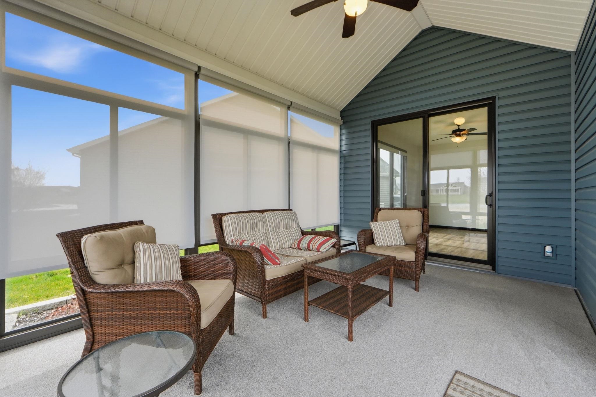 Sunroom / solarium featuring ceiling fan, outdoor furniture, and healthy amount of natural light