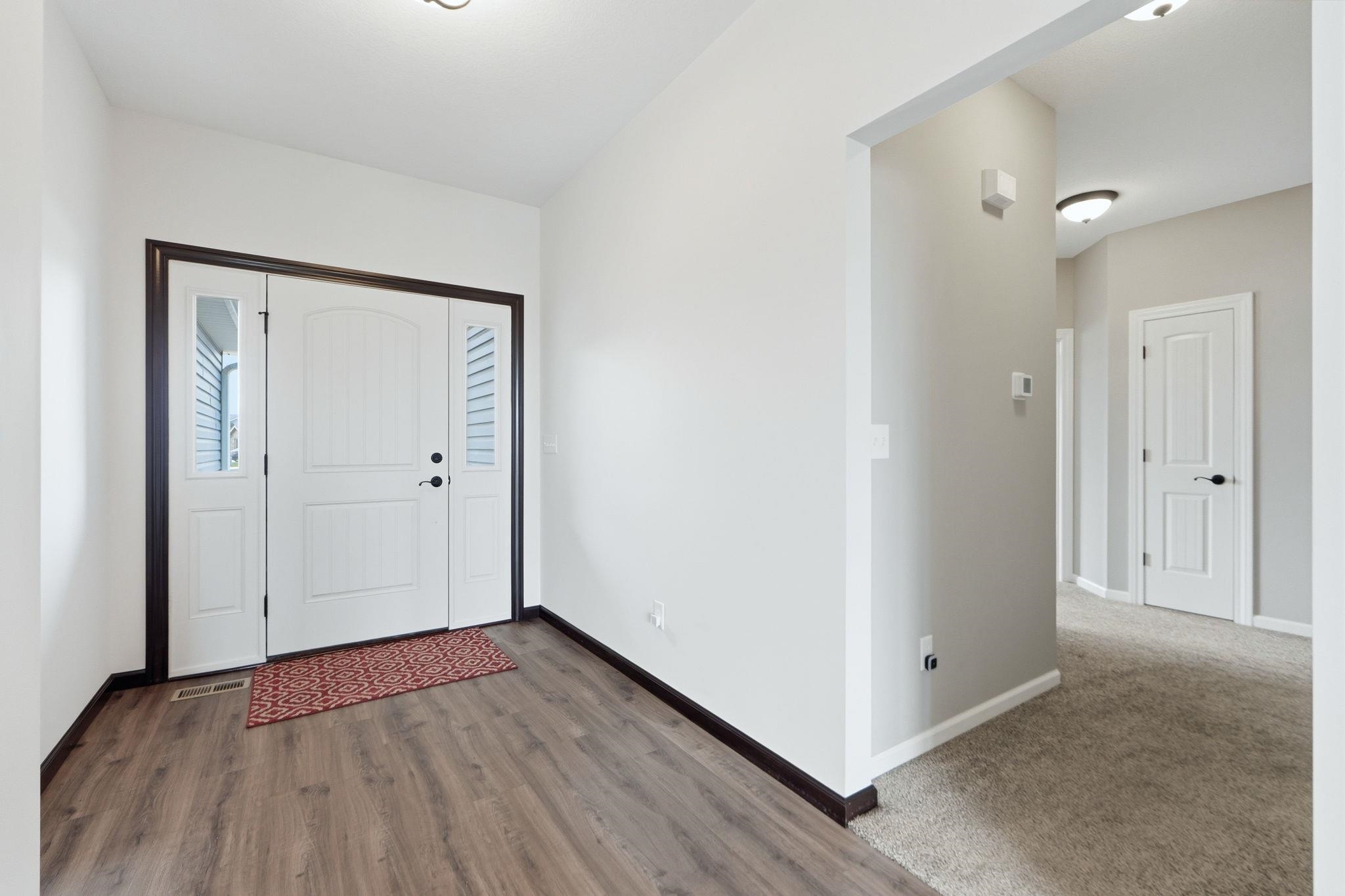Foyer entrance with baseboards and dark wood finished floors