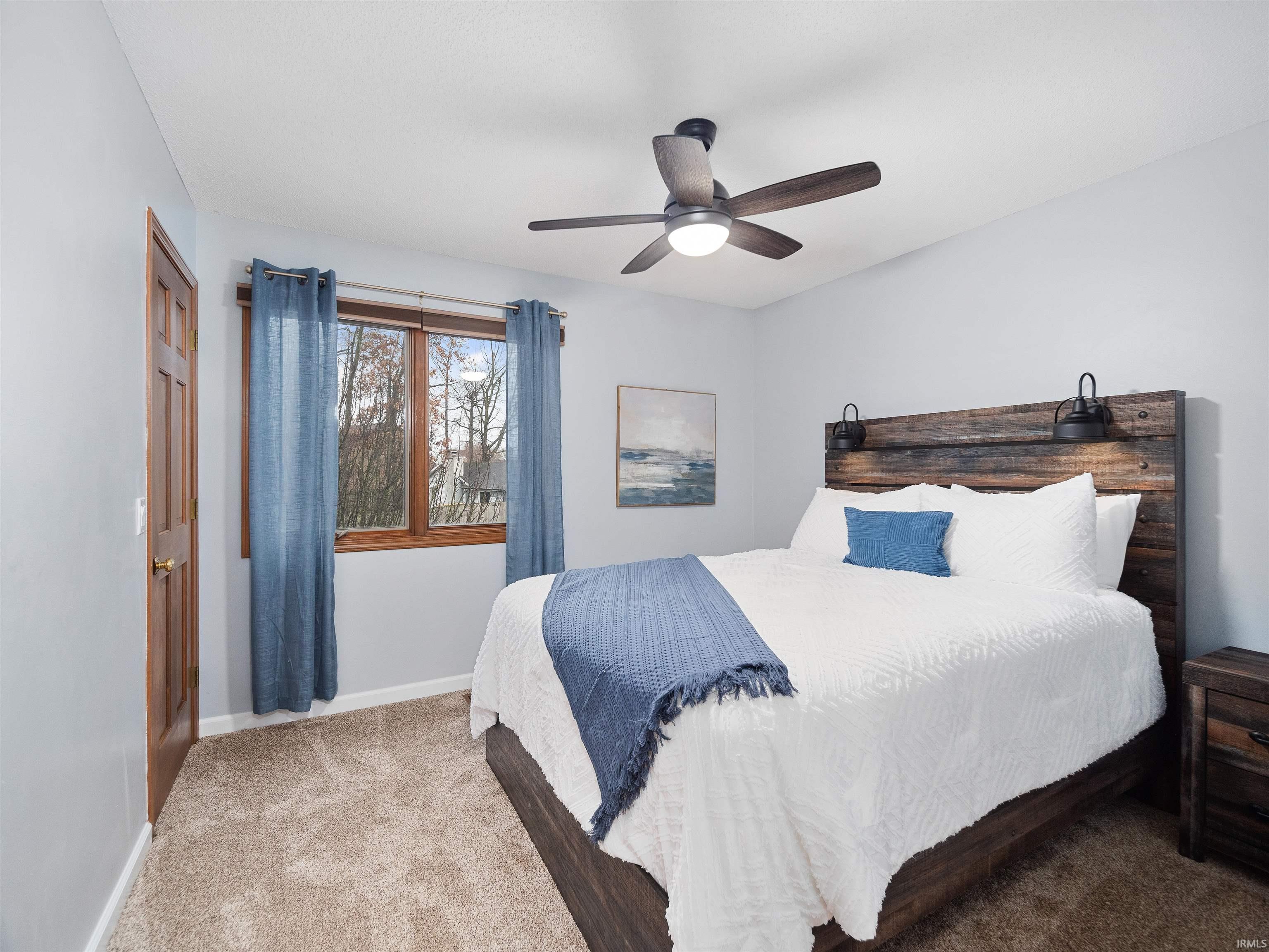Bedroom with carpet and a ceiling fan