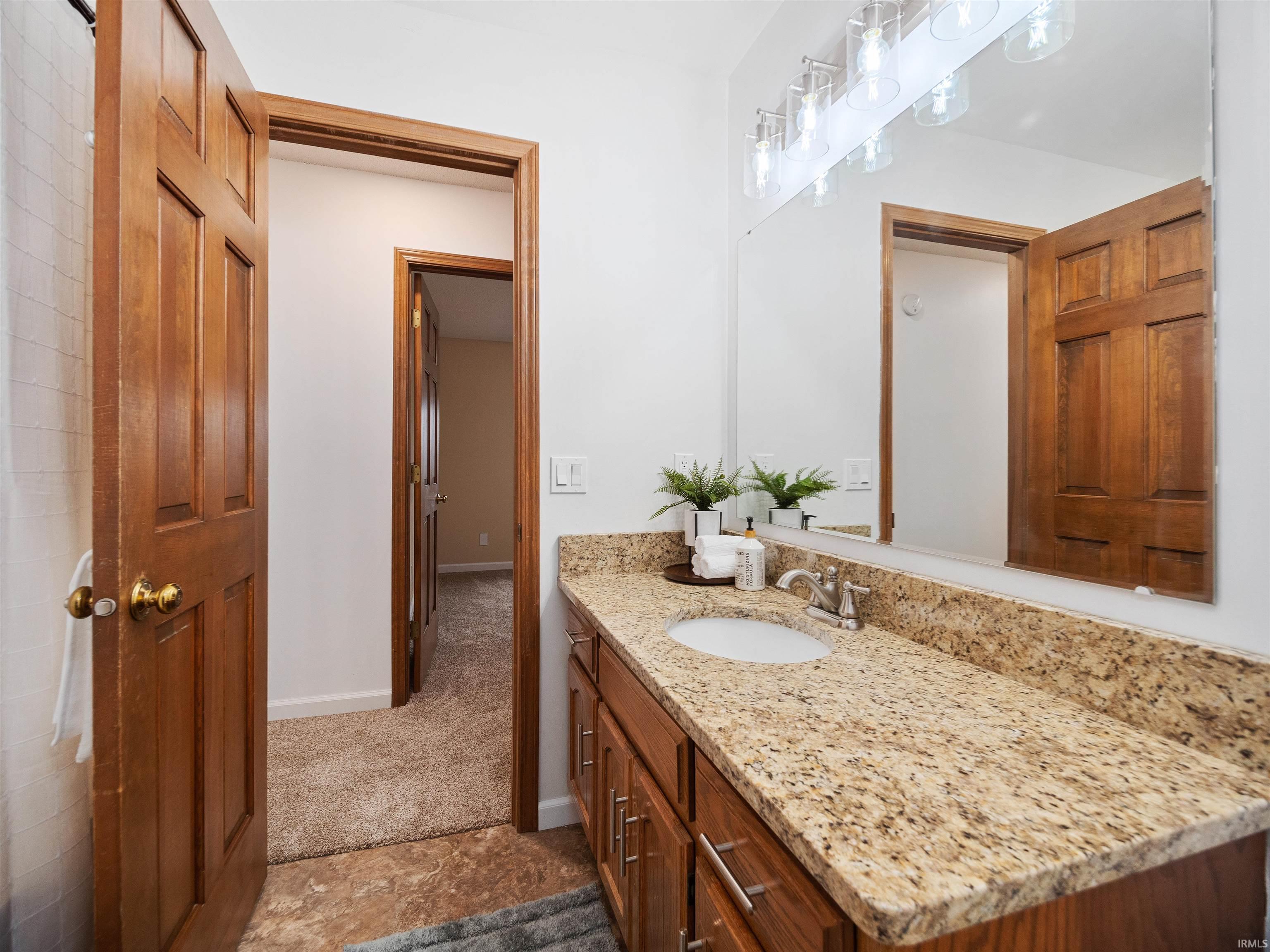 Bathroom featuring vanity and baseboards