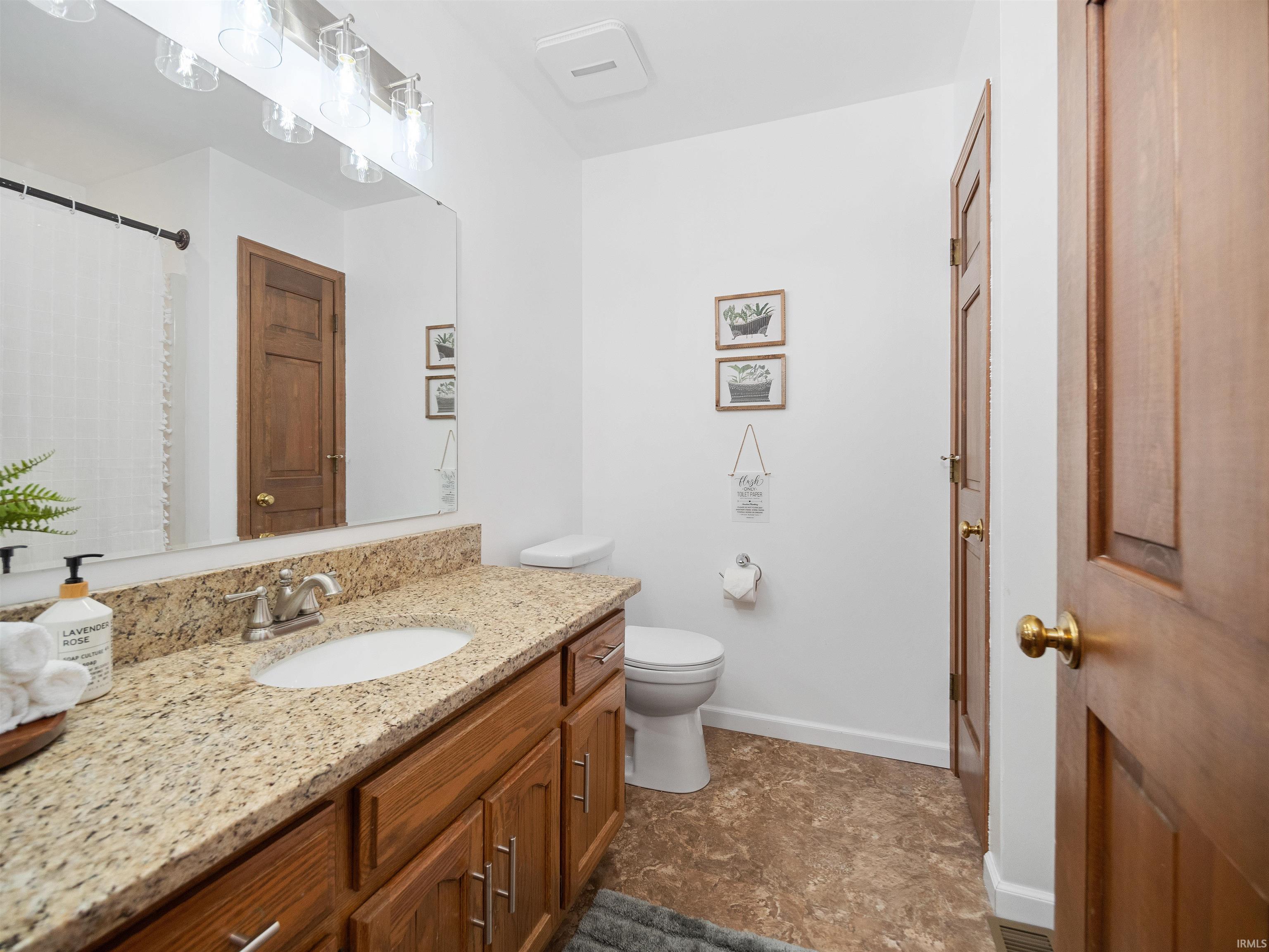 Bathroom featuring vanity and curtained shower