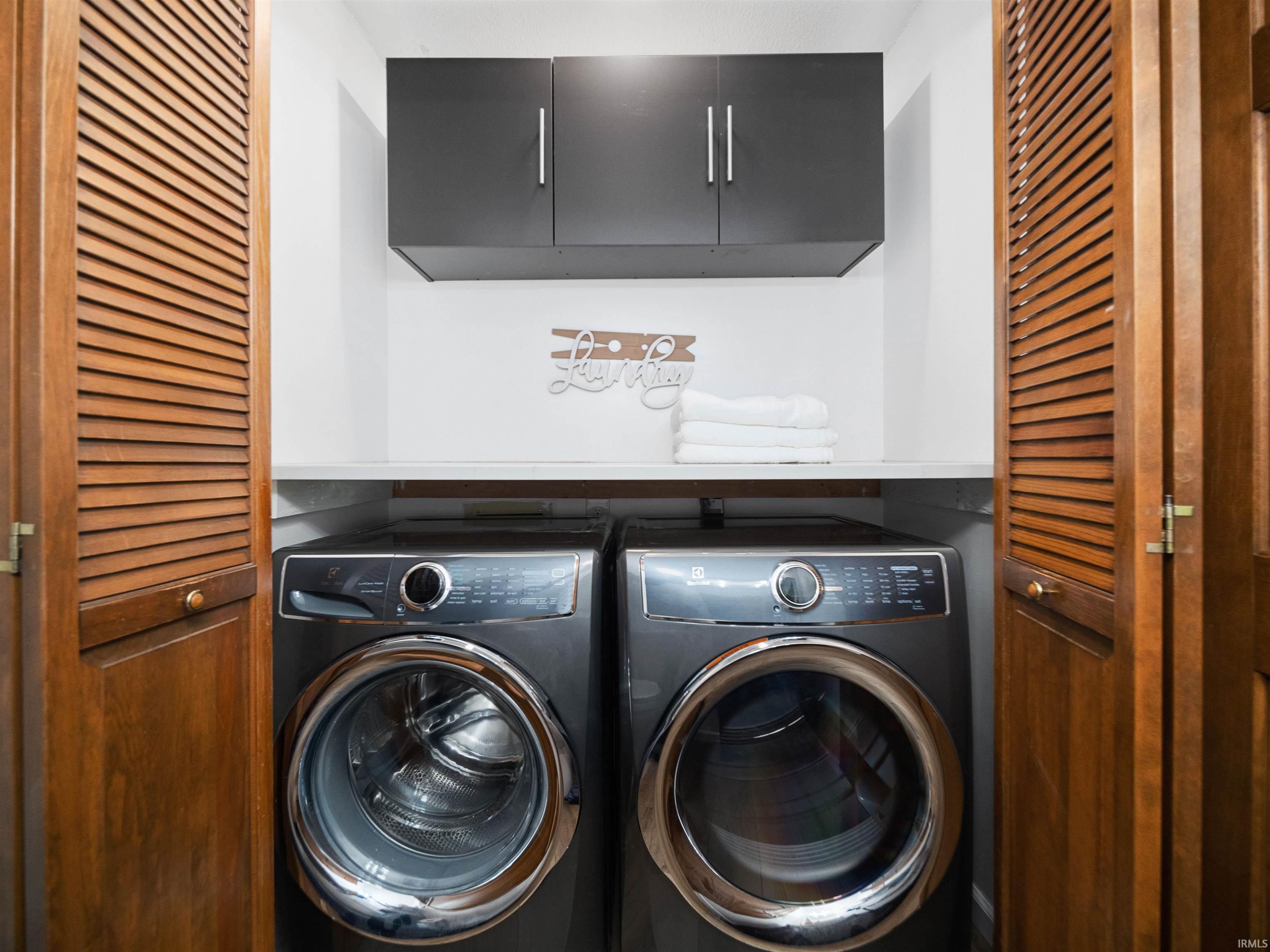 Laundry room featuring washer and dryer and cabinet space