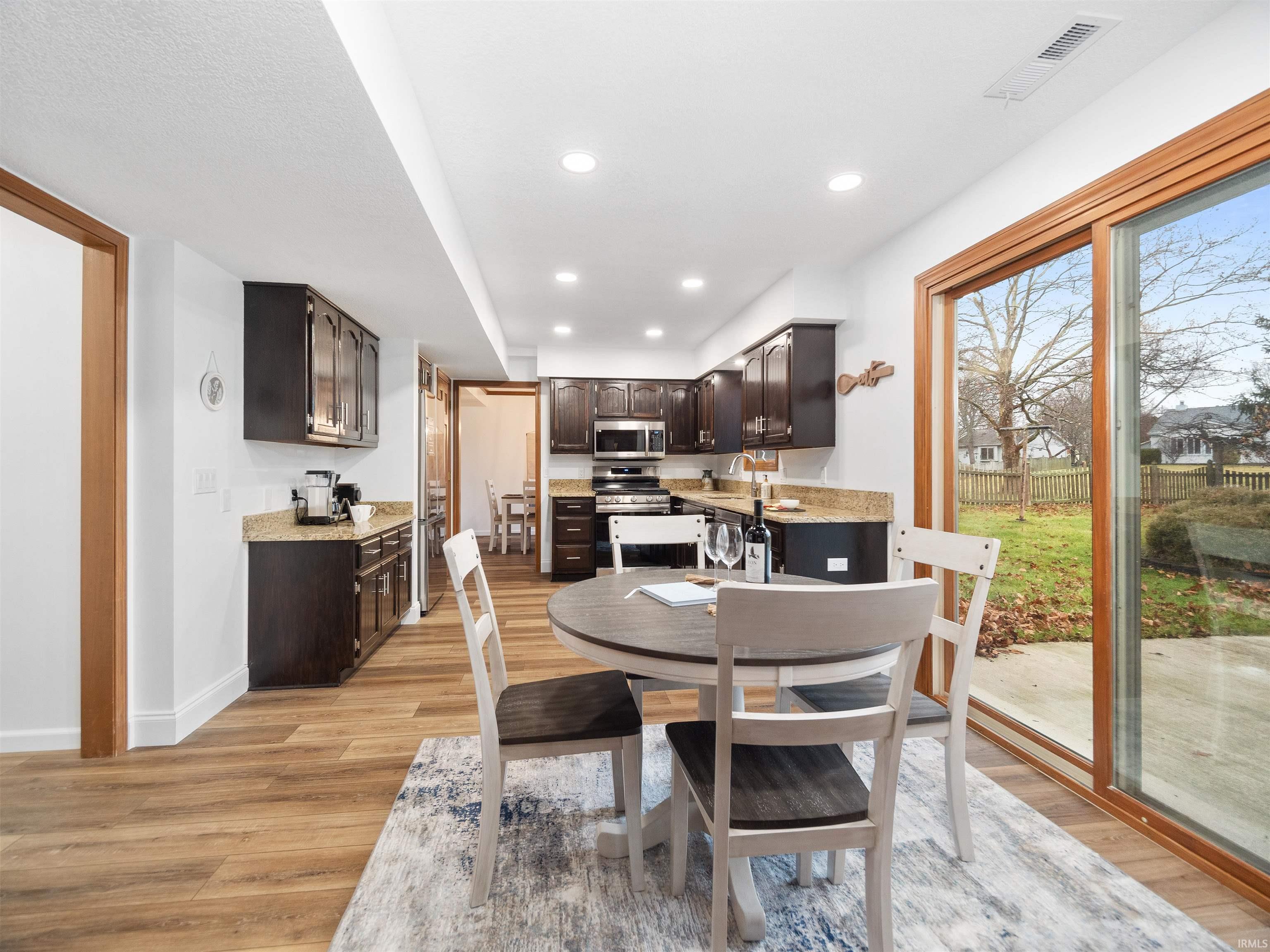 Breakfast space with light wood-style flooring and recessed lighting