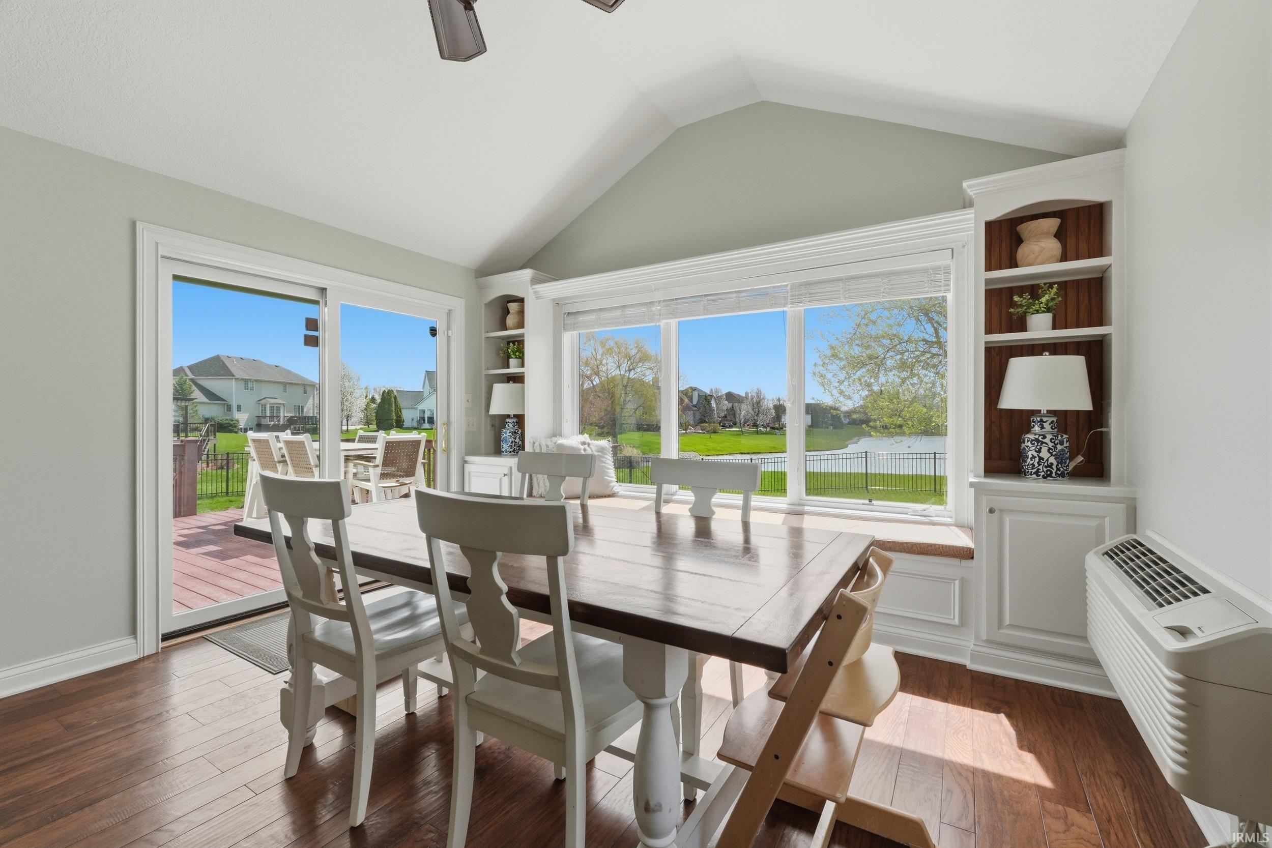 Dining space featuring ceiling fan, dark wood-type flooring, and built in features