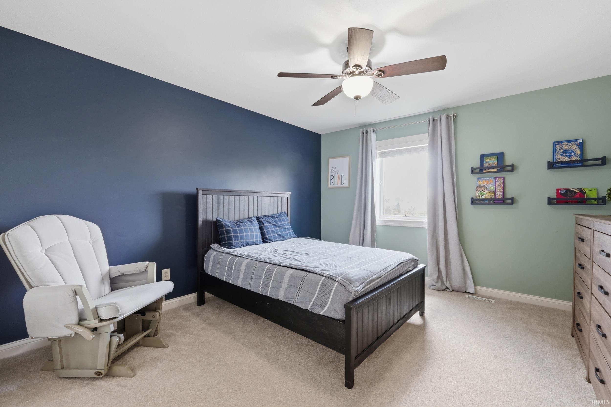 Bedroom featuring light colored carpet and a ceiling fan
