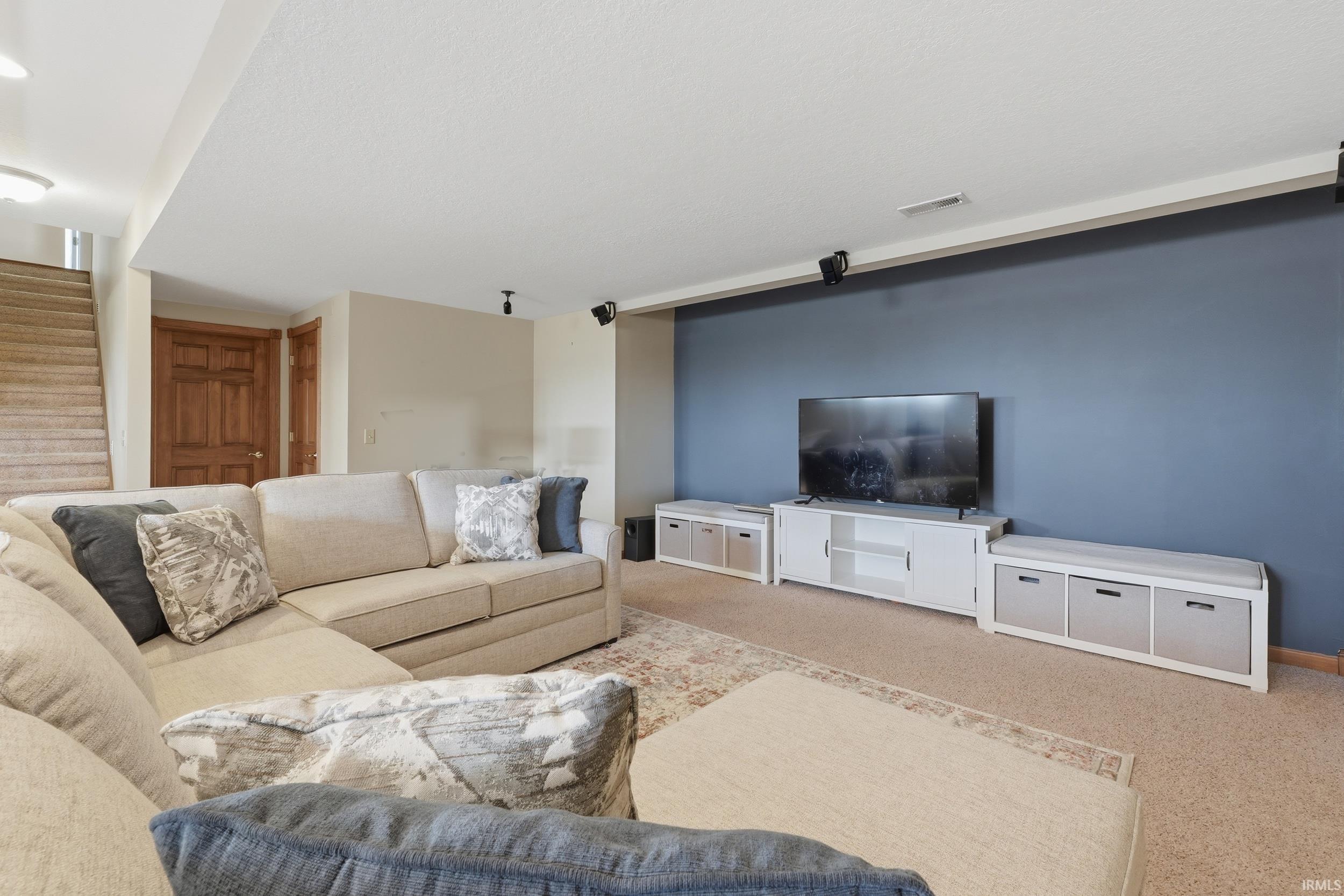Living room with stairs and carpet