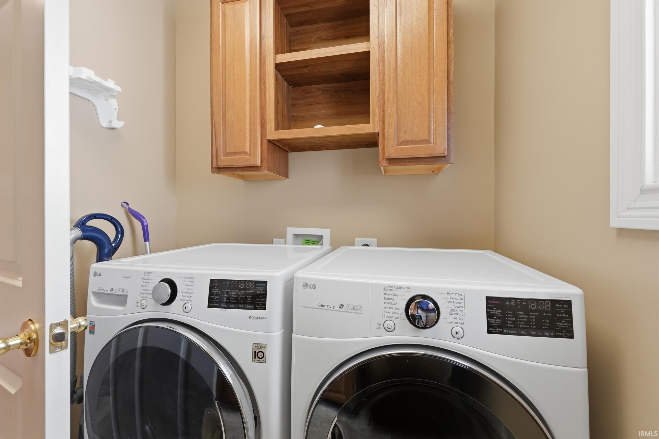 Laundry room with cabinet space and washing machine and clothes dryer