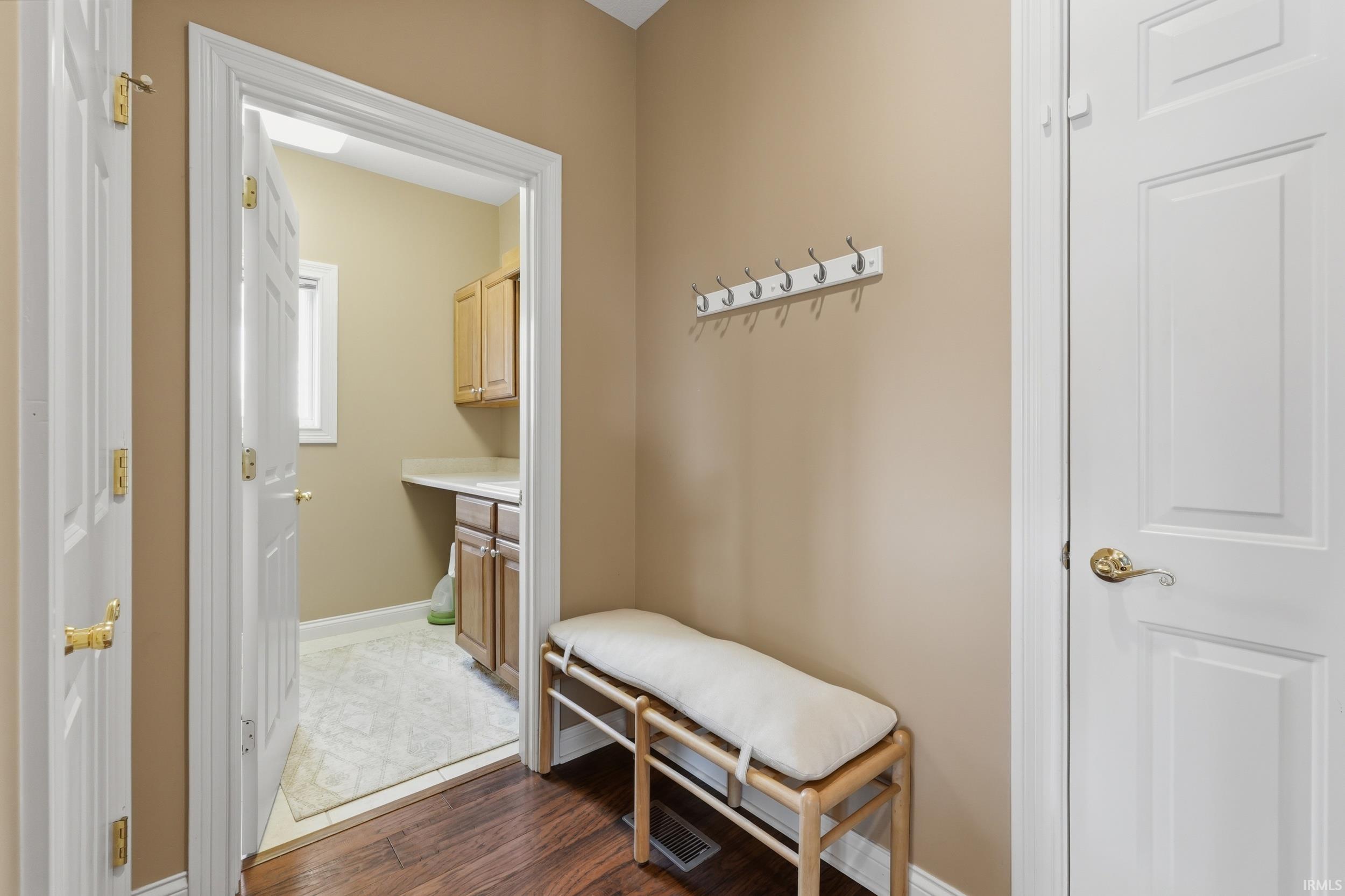 Mudroom with dark wood-style floors and baseboards