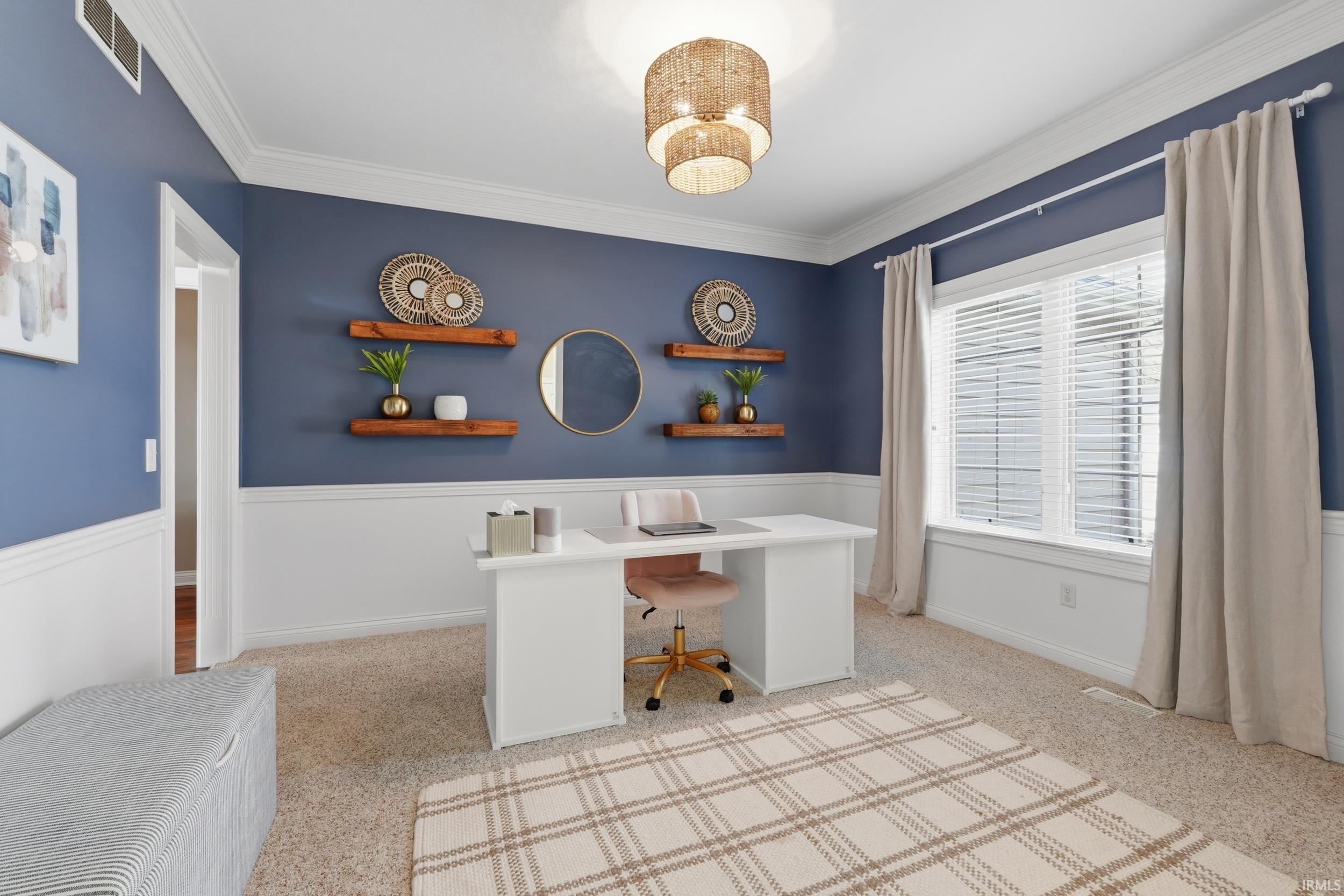 Office area with light colored carpet and ornamental molding