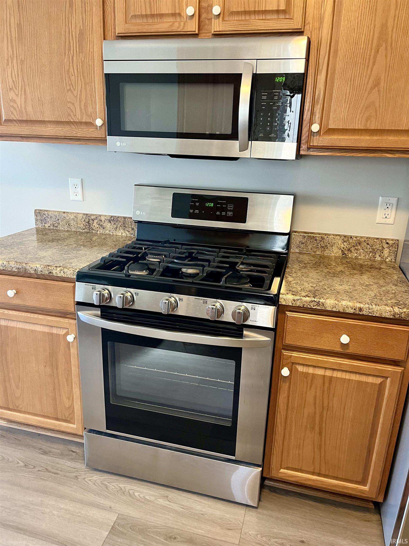 Kitchen featuring stainless steel appliances, light wood-style flooring, and wood finish cabinetry