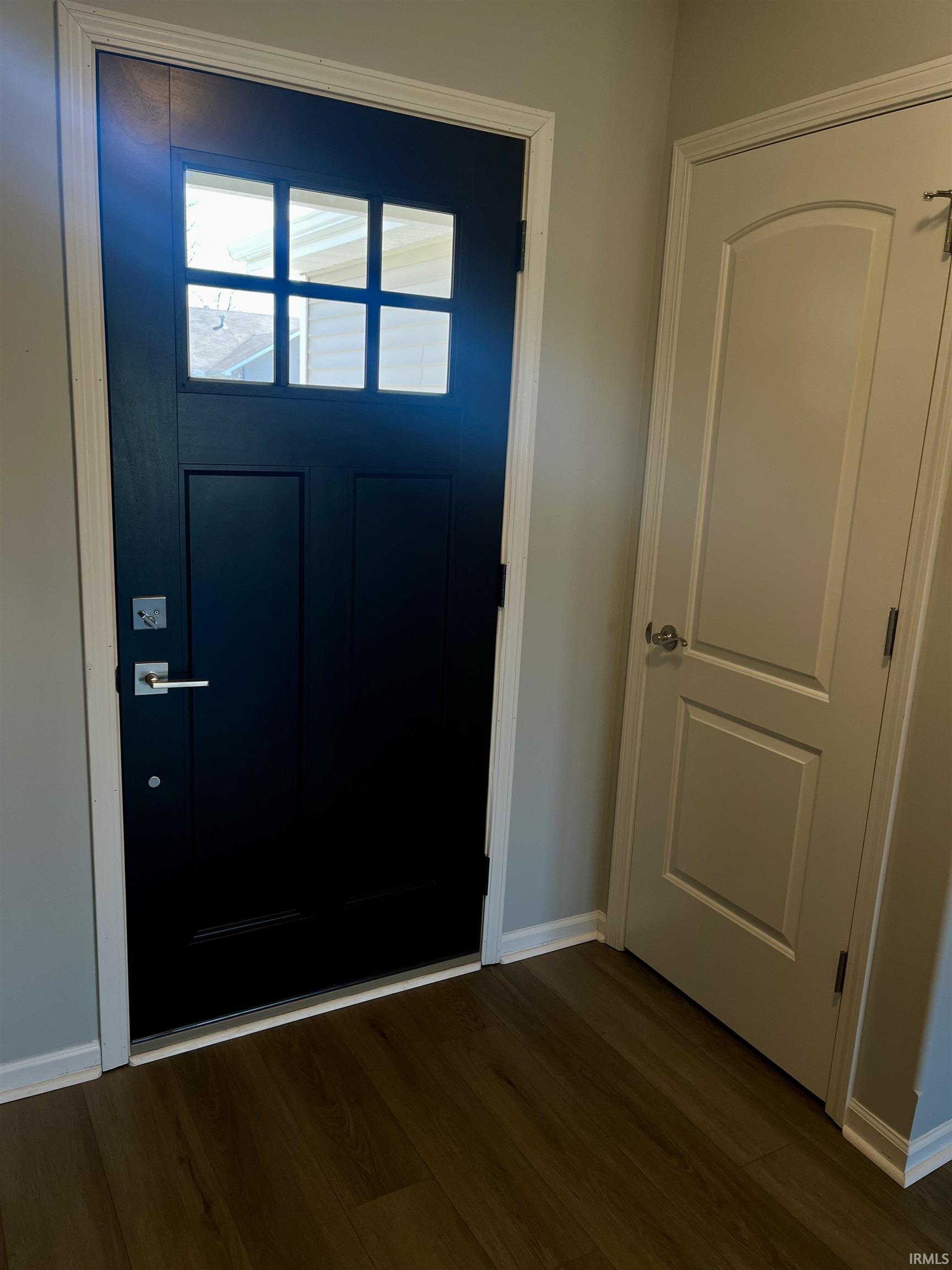 Entryway featuring wood finished floors and baseboards