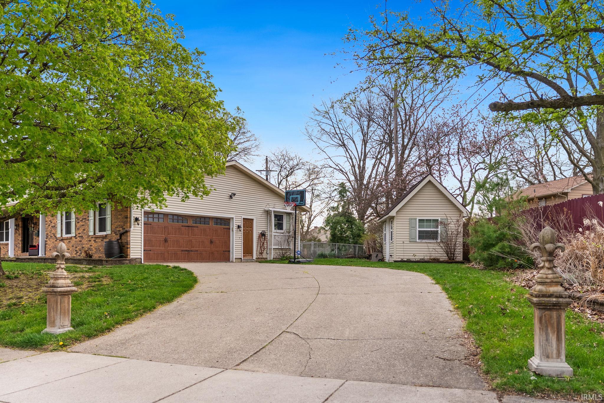 View of front of property featuring concrete driveway