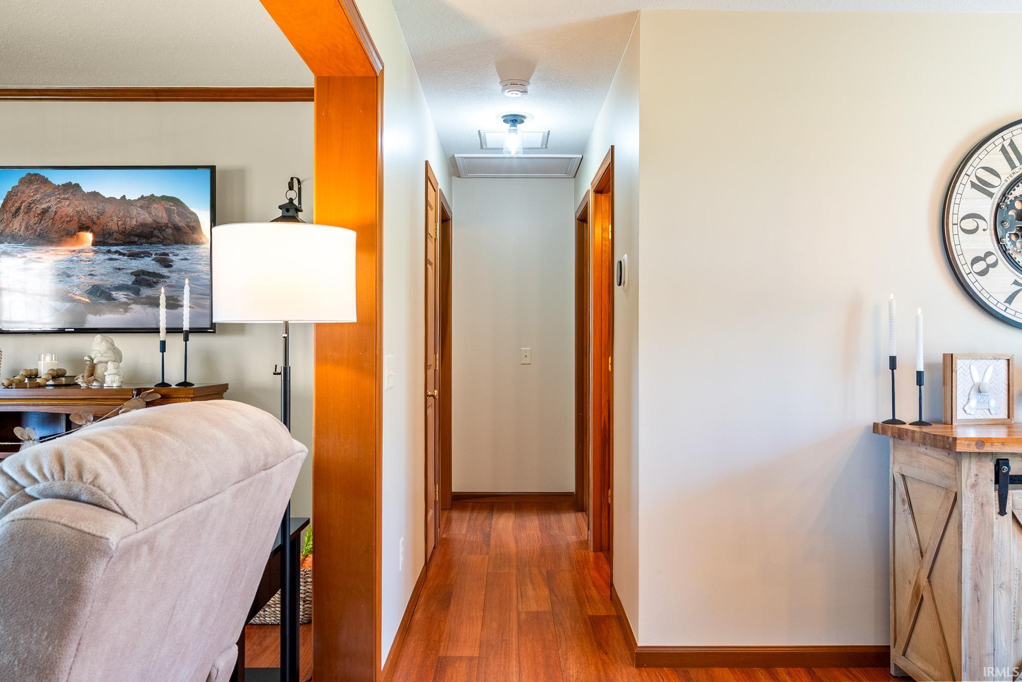 Hall featuring wood finished floors and baseboards